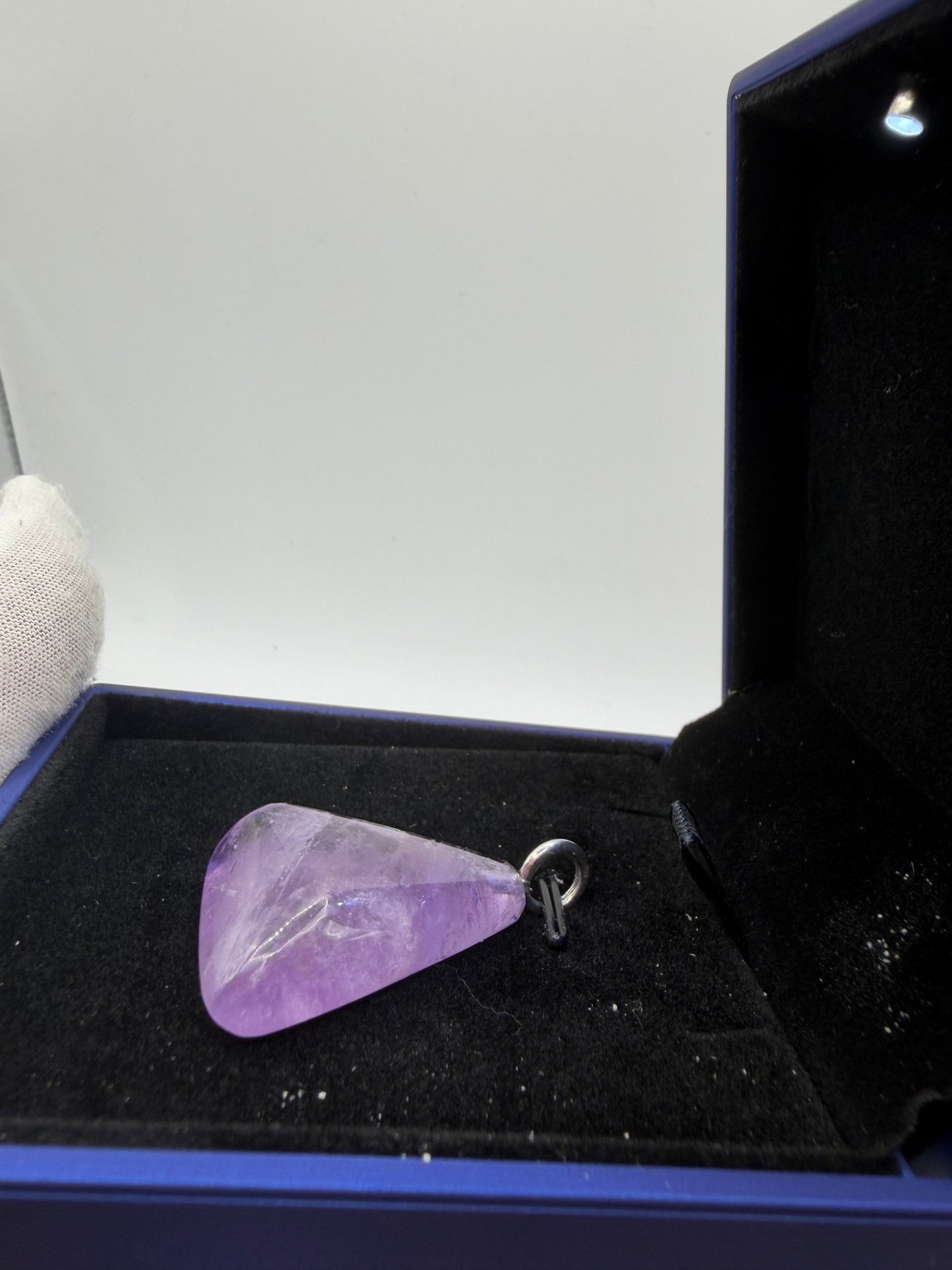 Close-up of natural Rwandan amethyst pendant showing deep violet saturation and clarity