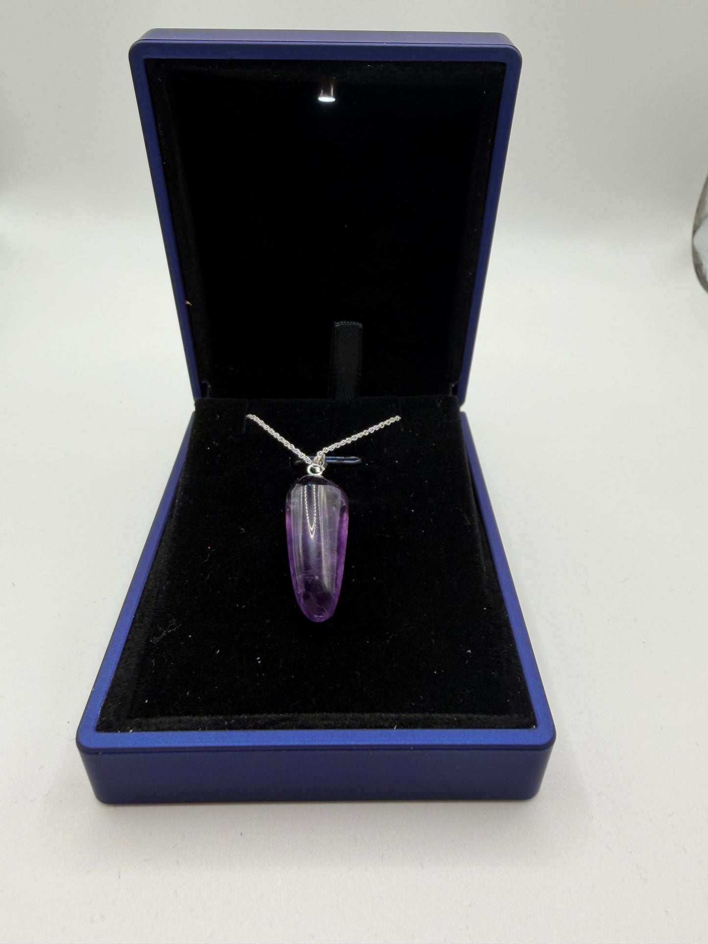 Close-up of 21ct natural Rwandan amethyst cabochon showing deep purple color and good clarity