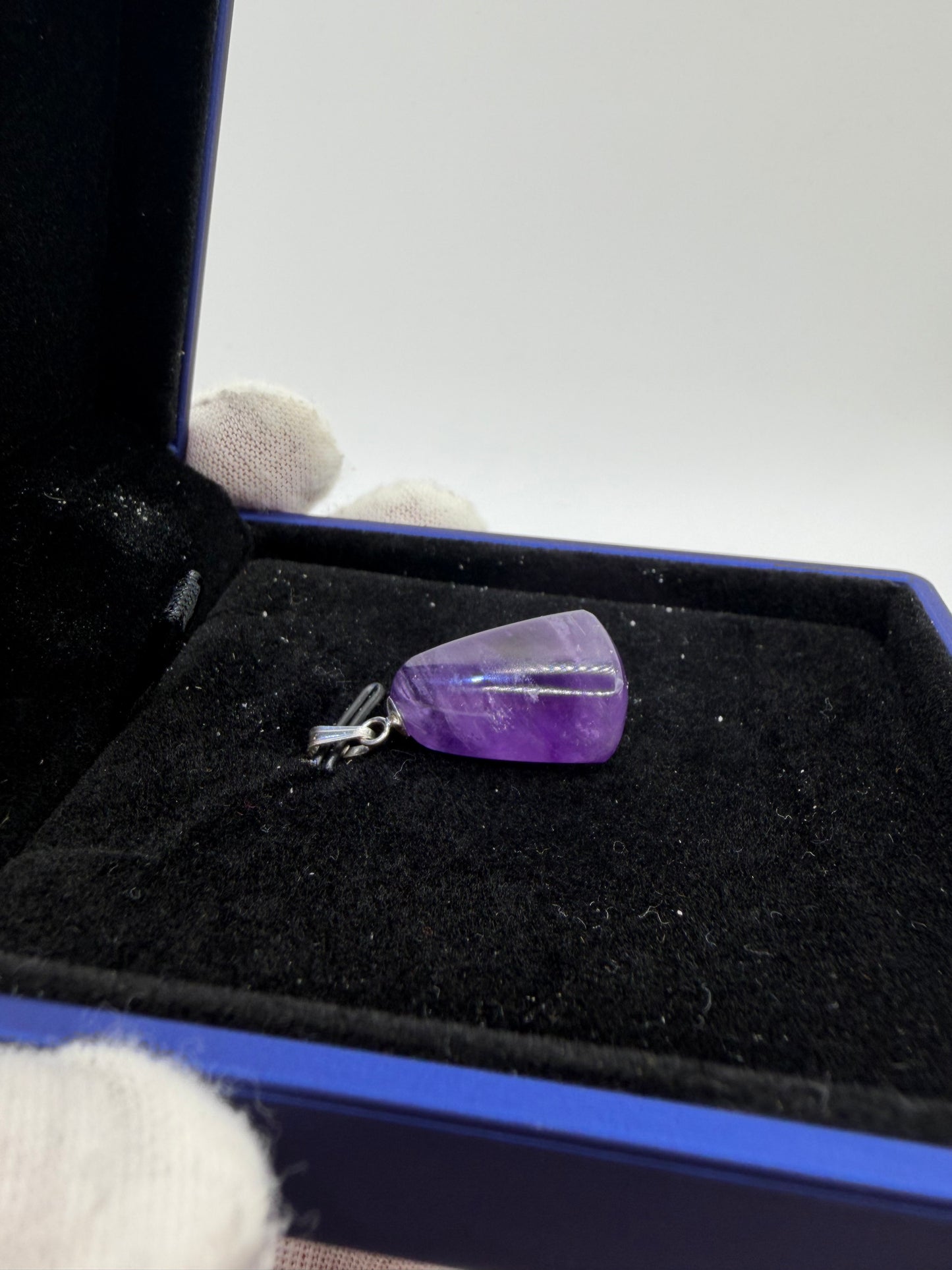 Side profile of 21ct Rwandan amethyst pendant with drilled sterling silver bail