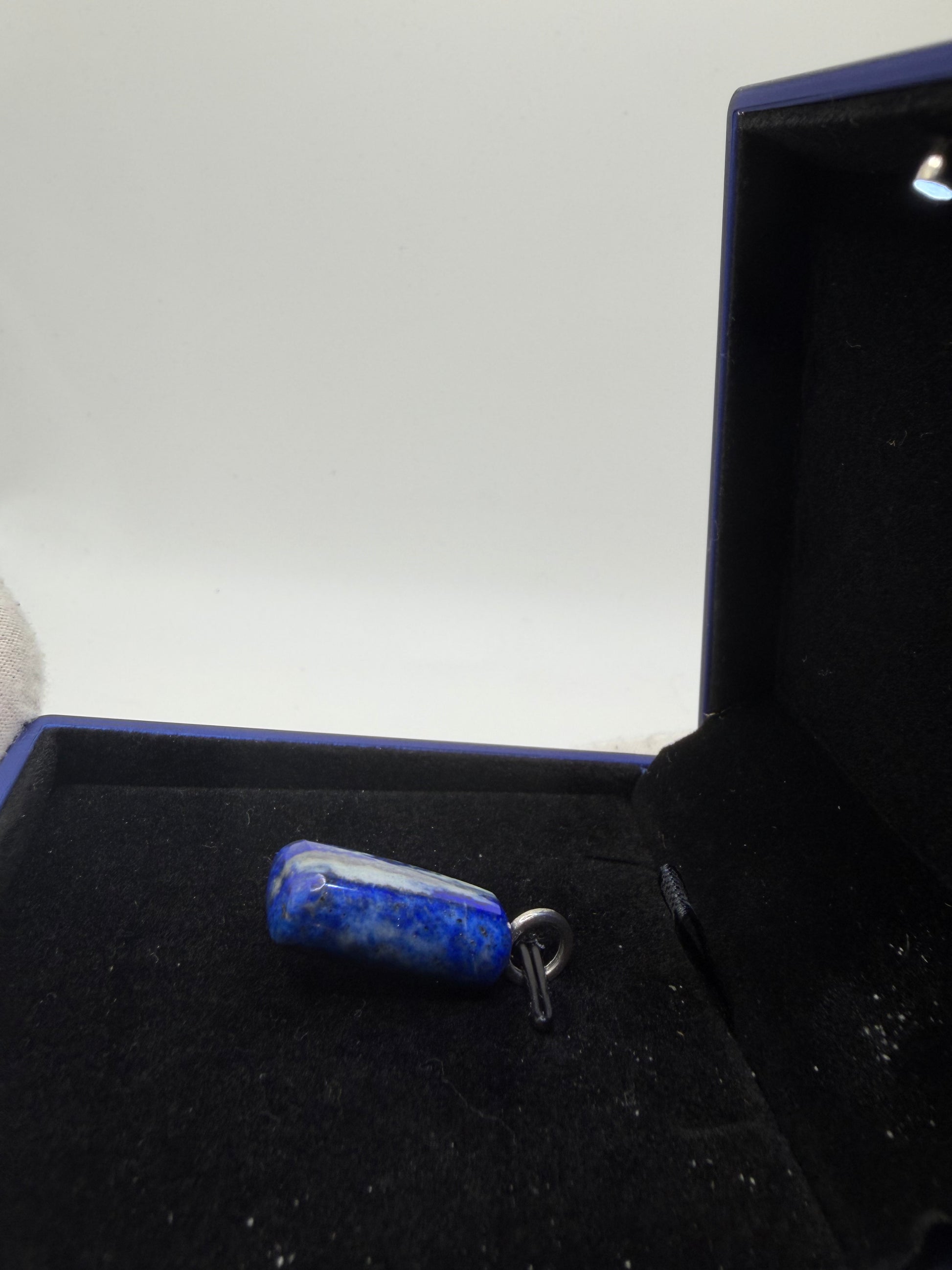 Side view of large natural Lapis Lazuli gemstone pendant with sterling silver bail — one-of-a-kind handcrafted jewelry