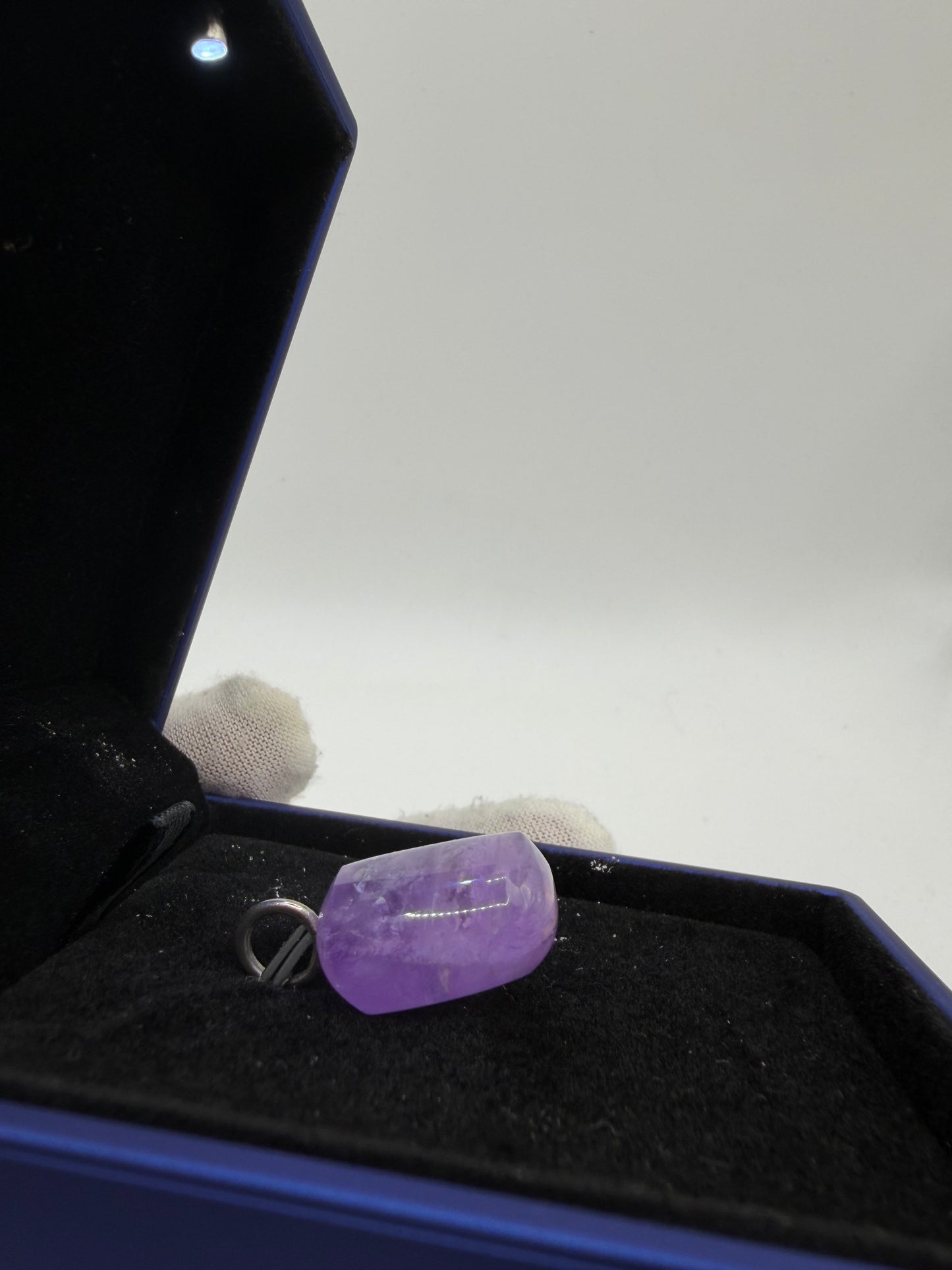 Side view of large natural Rwandan Amethyst gemstone pendant with sterling silver bail — untreated purple amethyst