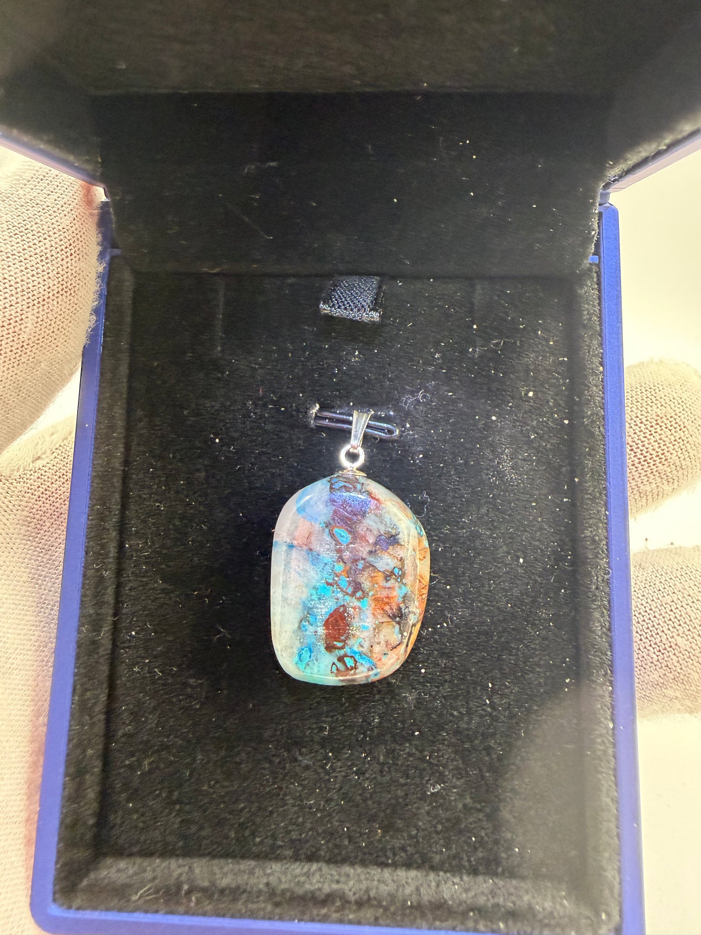 Close-up of 33ct Quantum Quattro pendant showing vibrant blue-green mineral patterns and sterling silver 