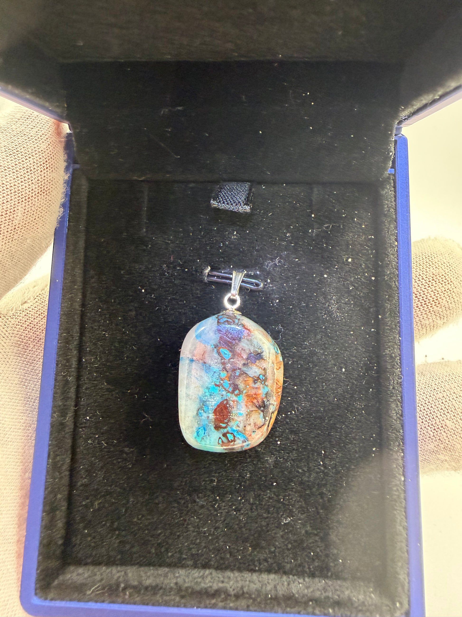 Close-up of 33ct Quantum Quattro pendant showing vibrant blue-green mineral patterns and sterling silver 