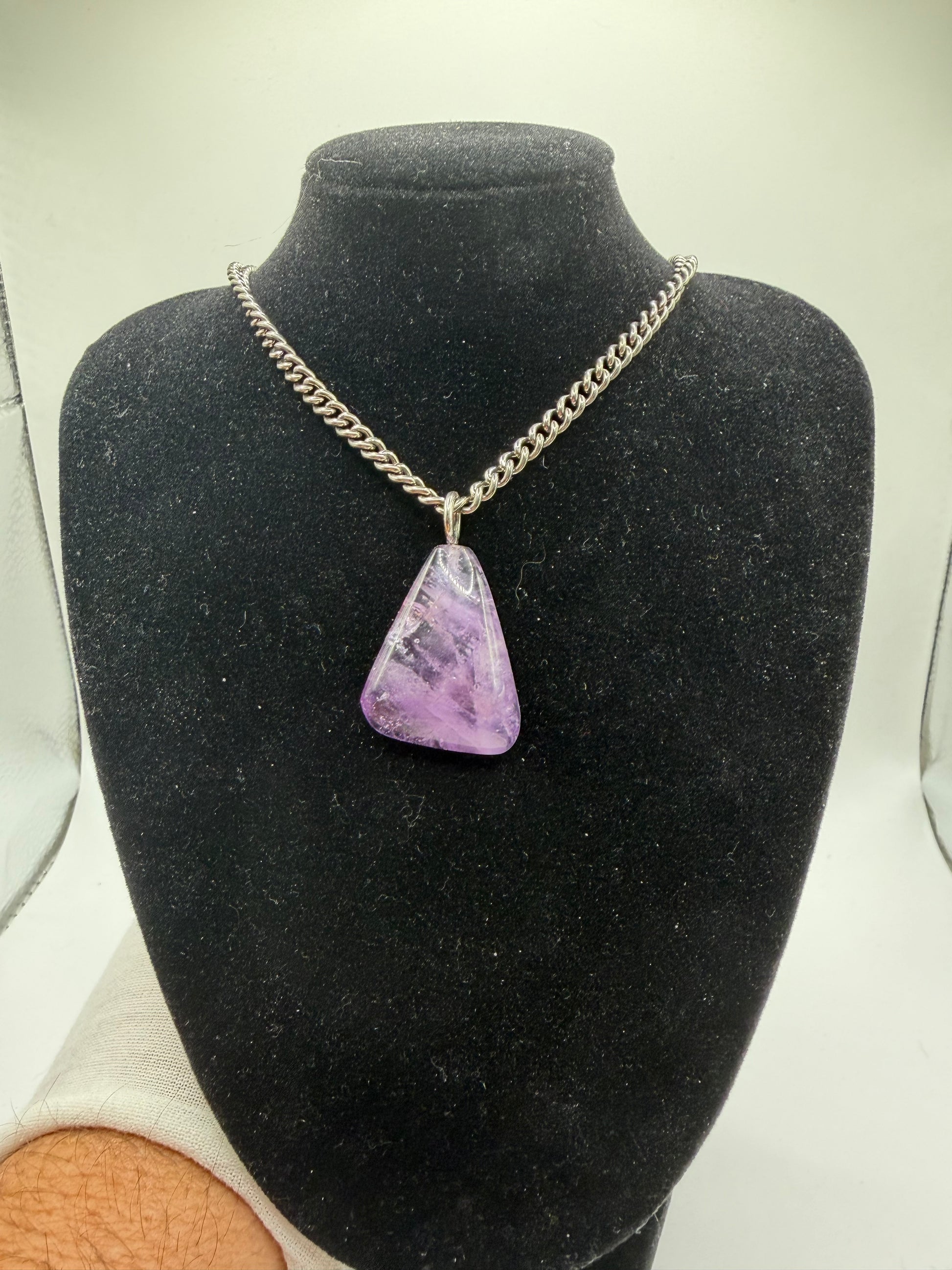 Natural Rwandan amethyst gemstone pendant showing rich violet color and sterling silver bail