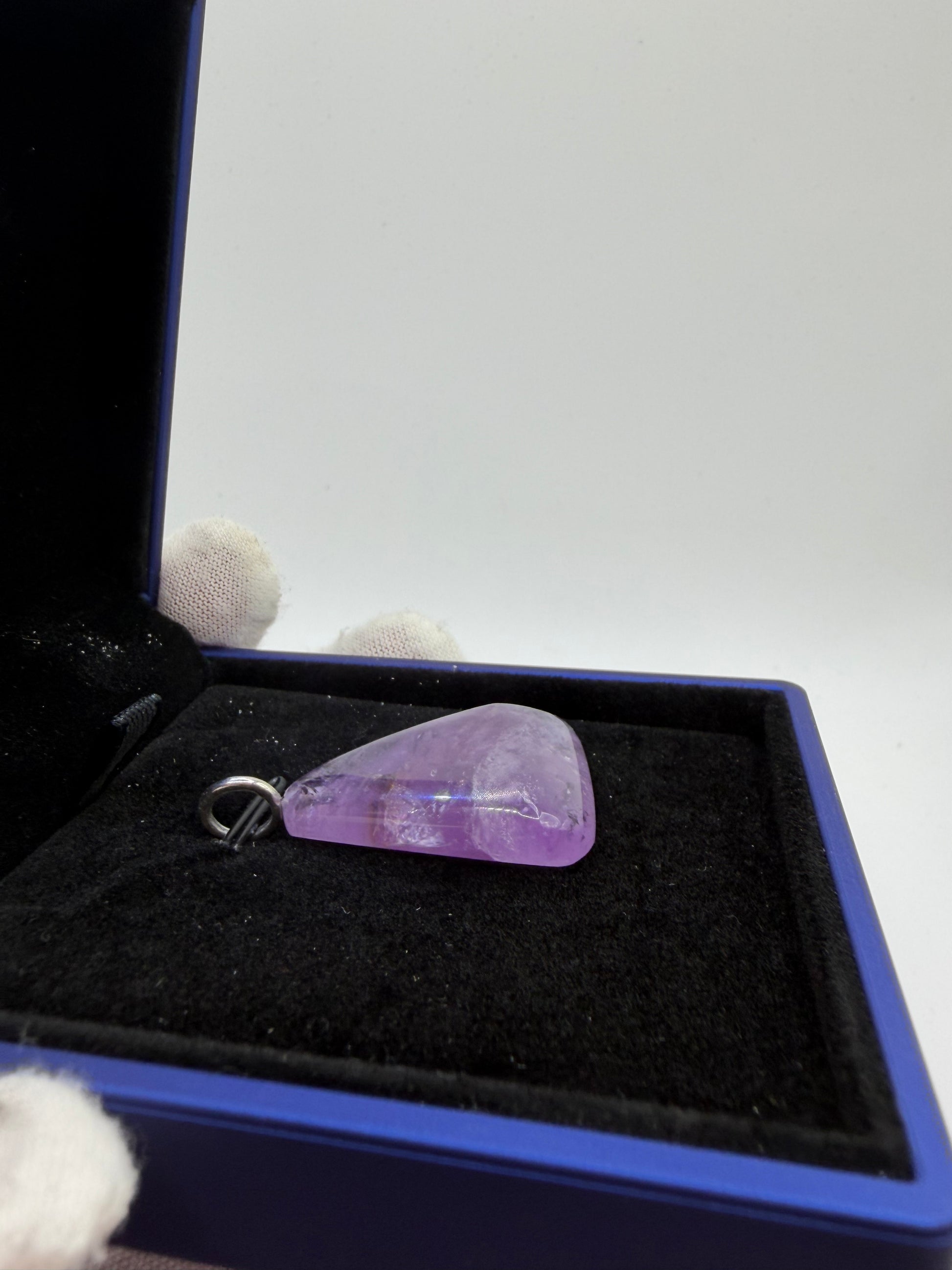 Side view of 49 carat Rwandan amethyst pendant with precision drilled sterling silver bail