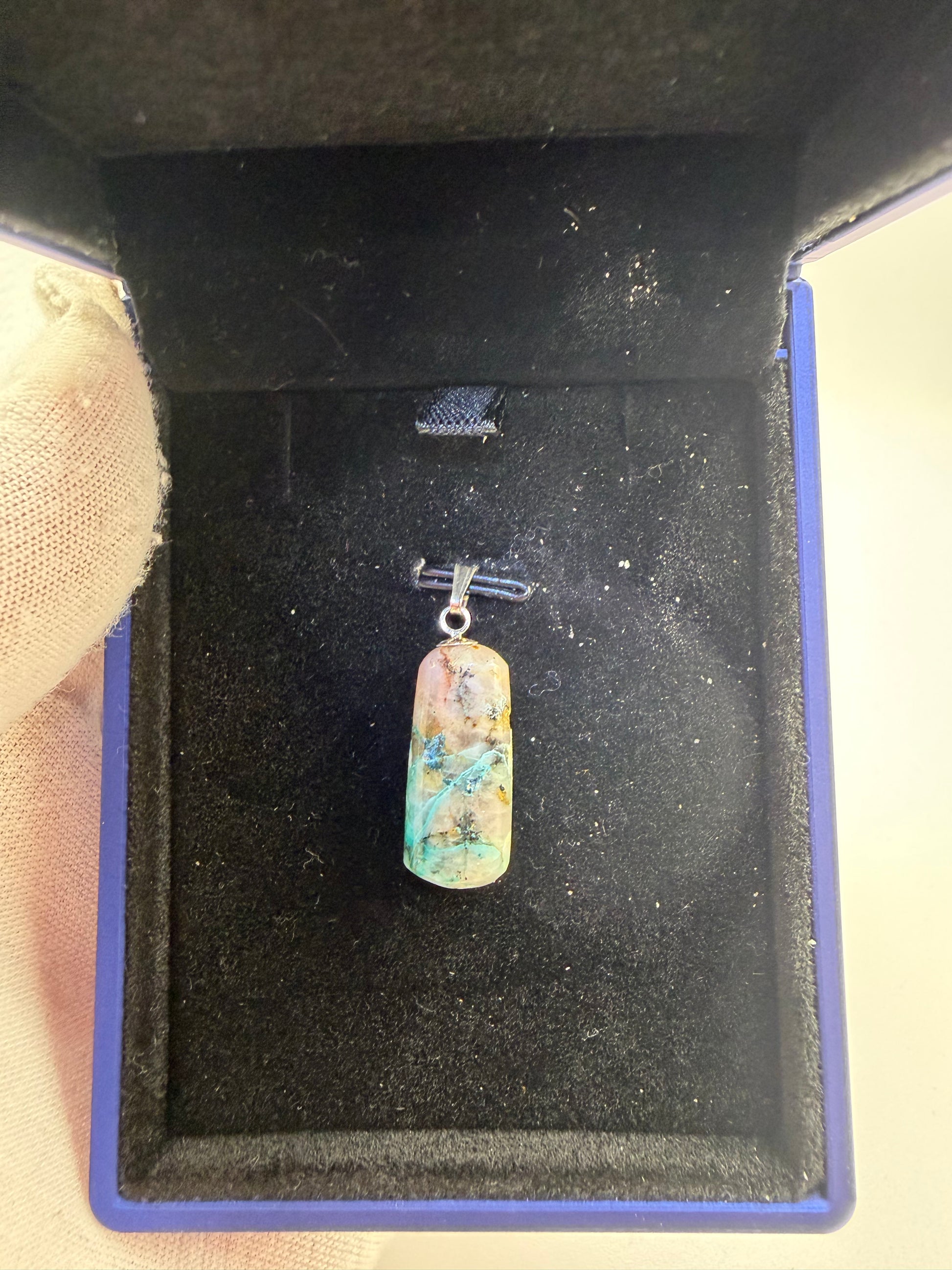 Close-up of 15ct Namibian Quantum Quattro pendant drill bail detail, artisan gemstone pendant handcrafted in Maine