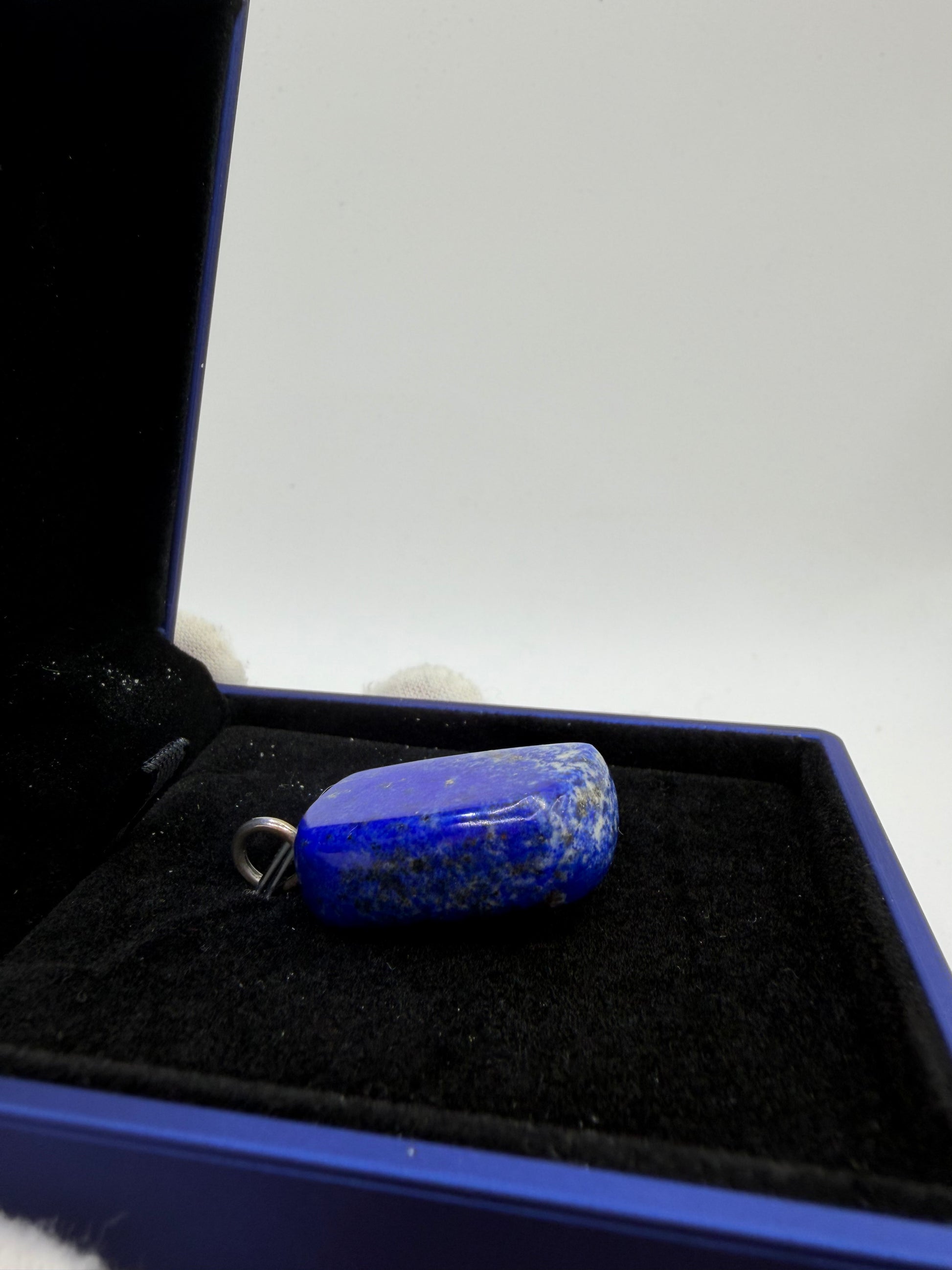 Side view of 75 carat lapis lazuli cabochon pendant with sterling silver drilled bail in jewelry box