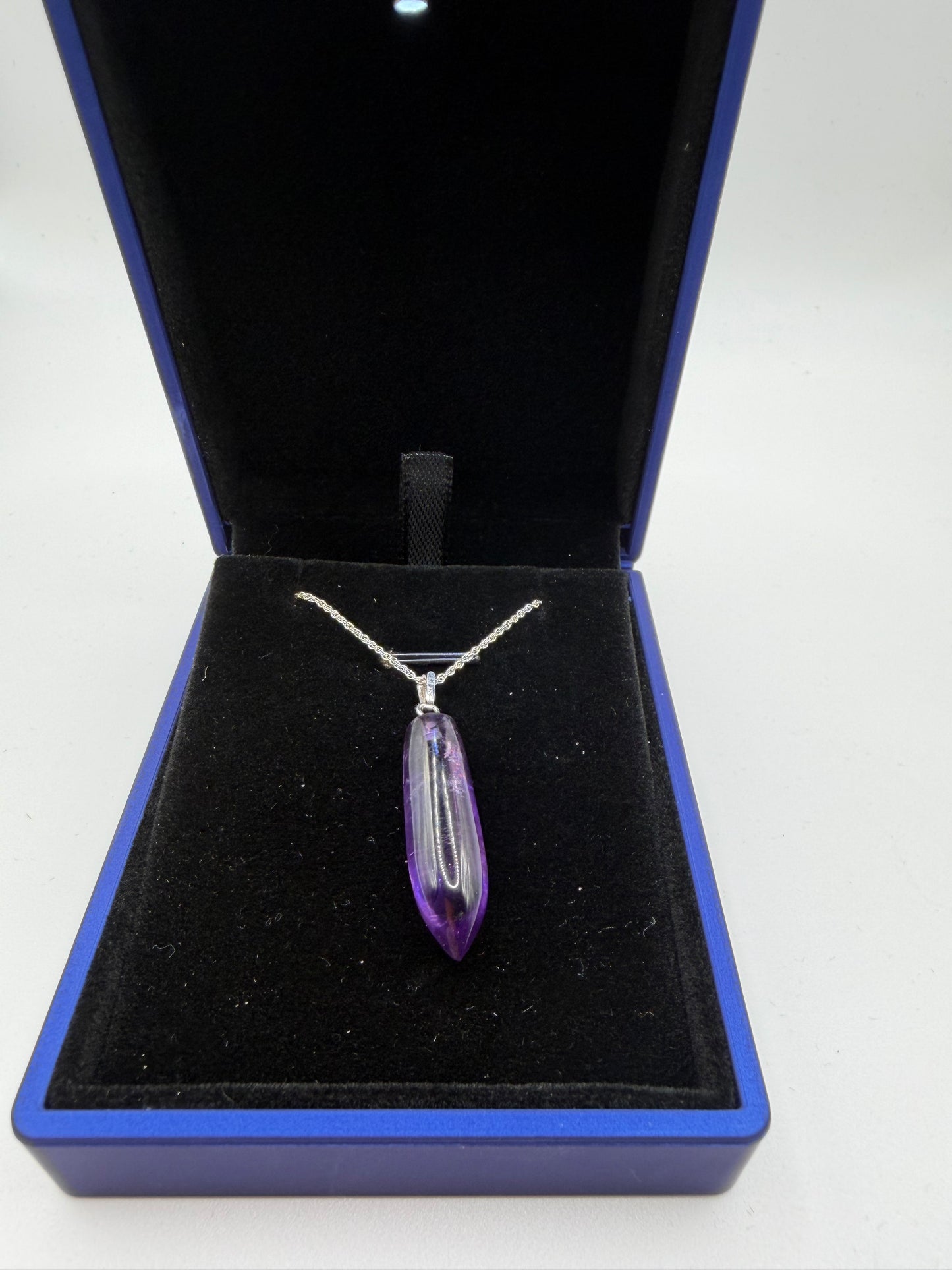 Close-up of 16ct natural Rwandan amethyst cabochon showing deep purple color and good clarity