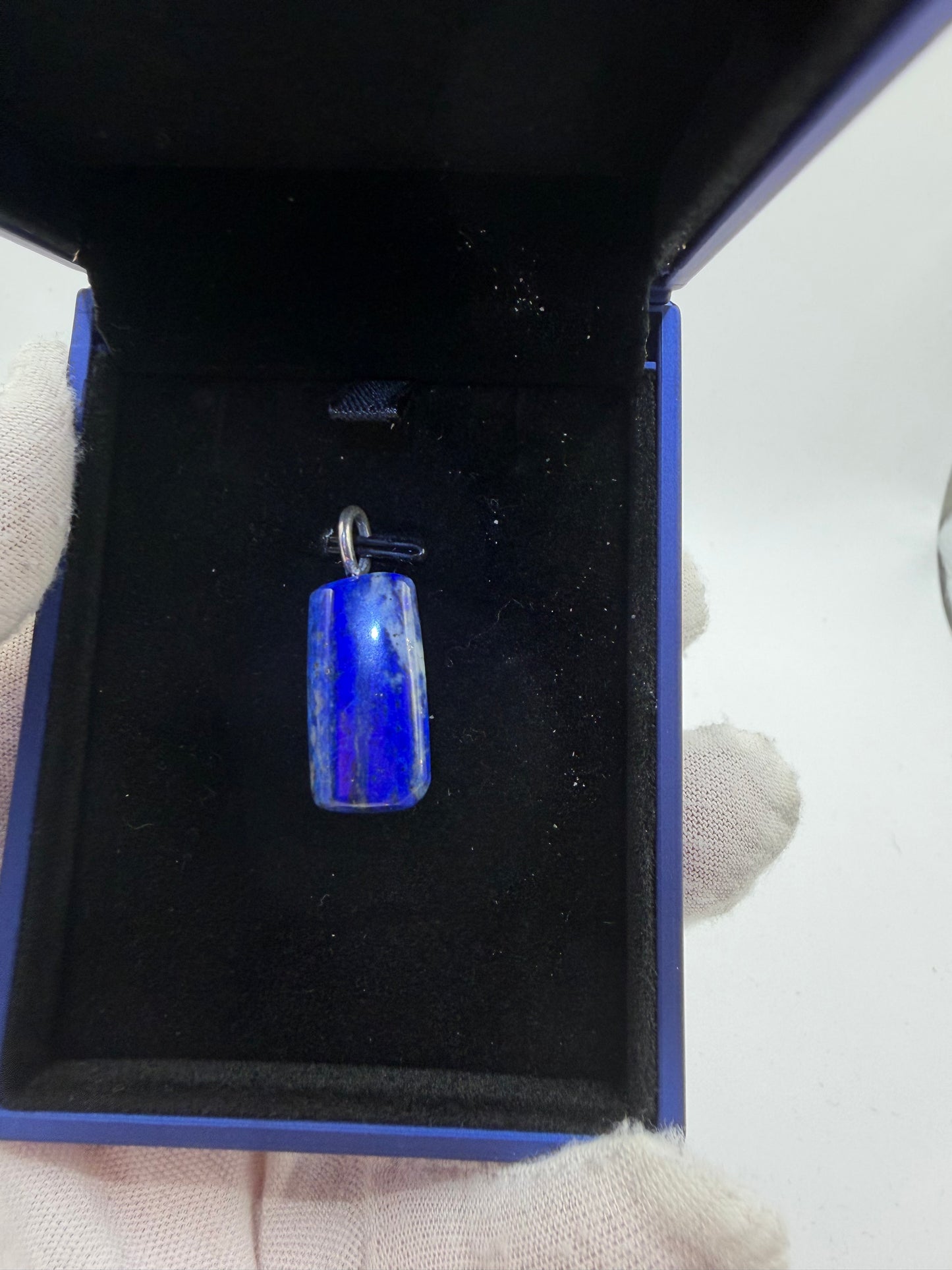Detail of 30ct Lapis Lazuli pendant stone surface — natural deep blue gemstone with pyrite inclusions, made in Maine
