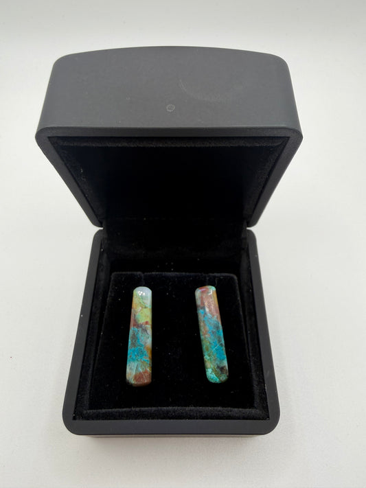 18tcw Namibian Quantum Quattro elongated bar cabochon stud earrings in vivid teal, terracotta, and yellow-green, displayed in open black jewelry box