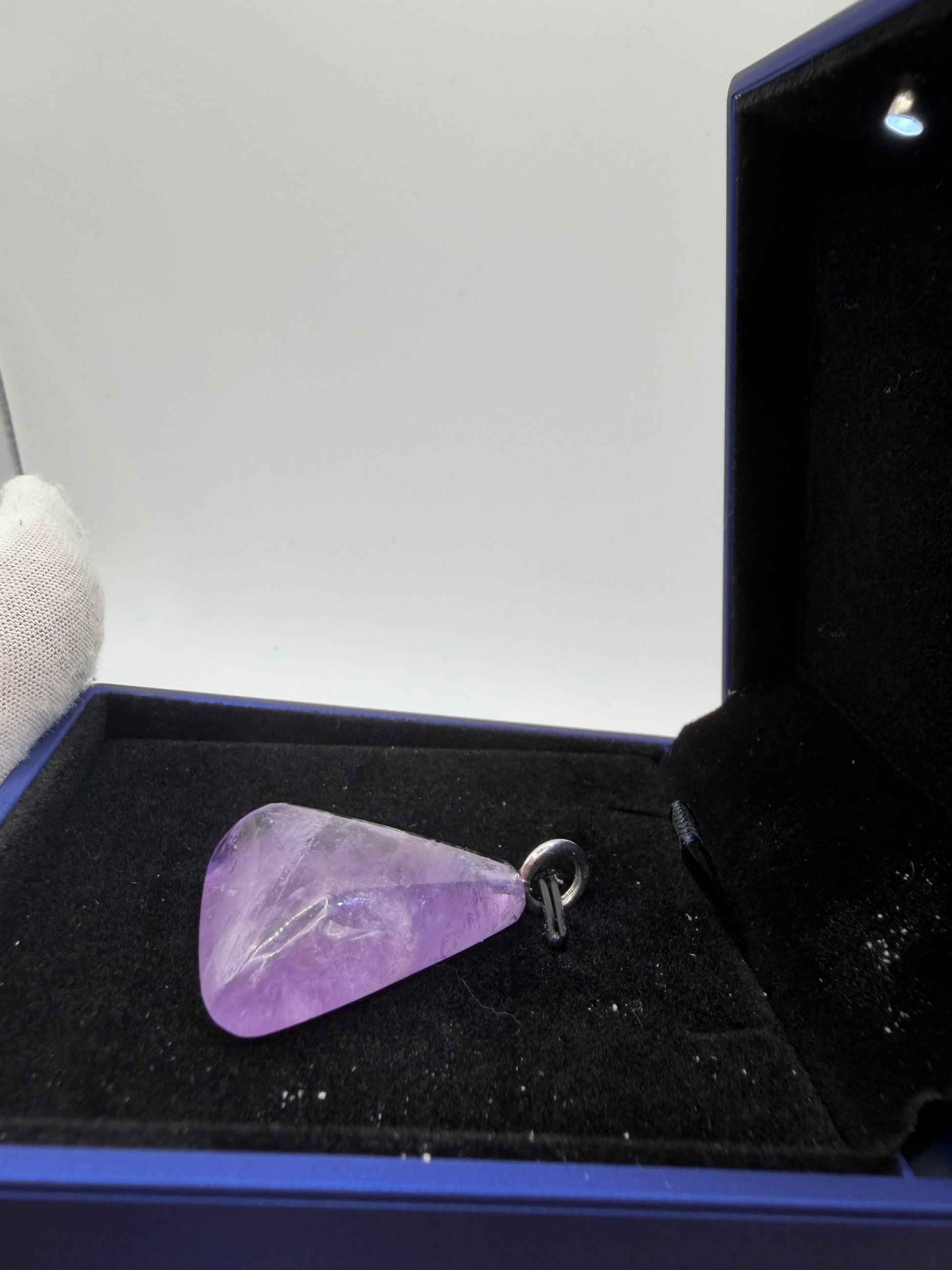 Close-up of natural Rwandan amethyst pendant showing deep violet saturation and clarity