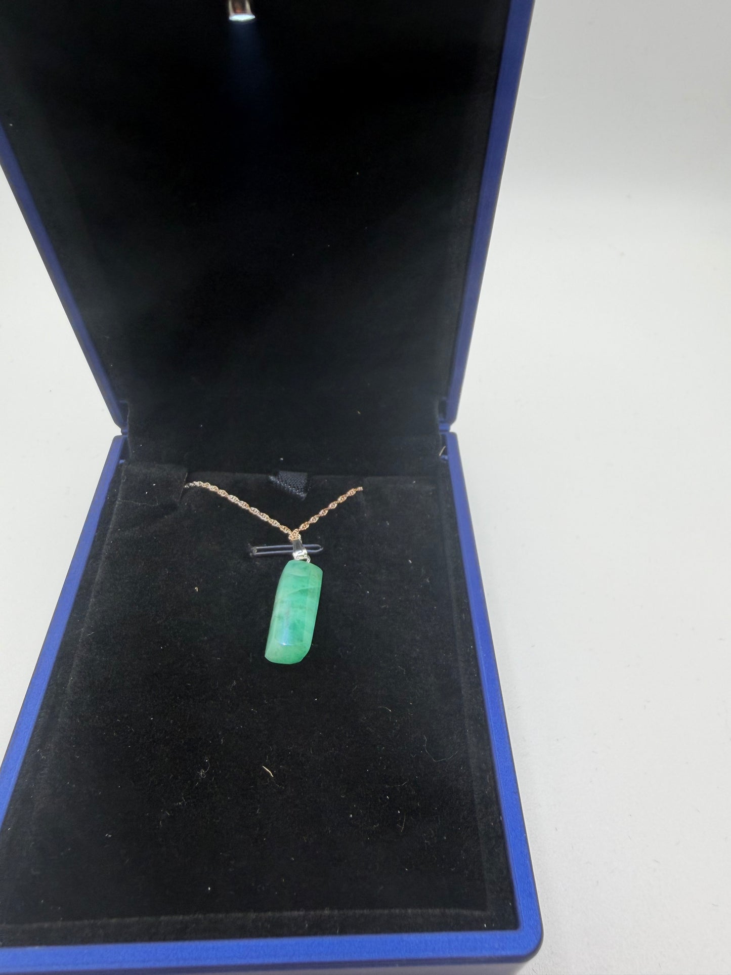 Close-up of 8ct natural Colombian emerald cabochon showing rich green color