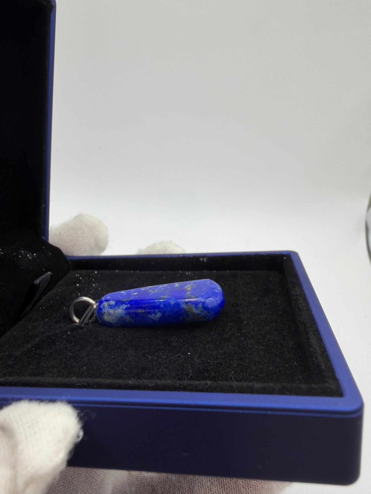 Natural lapis lazuli gemstone pendant with drilled sterling silver bail – side profile view