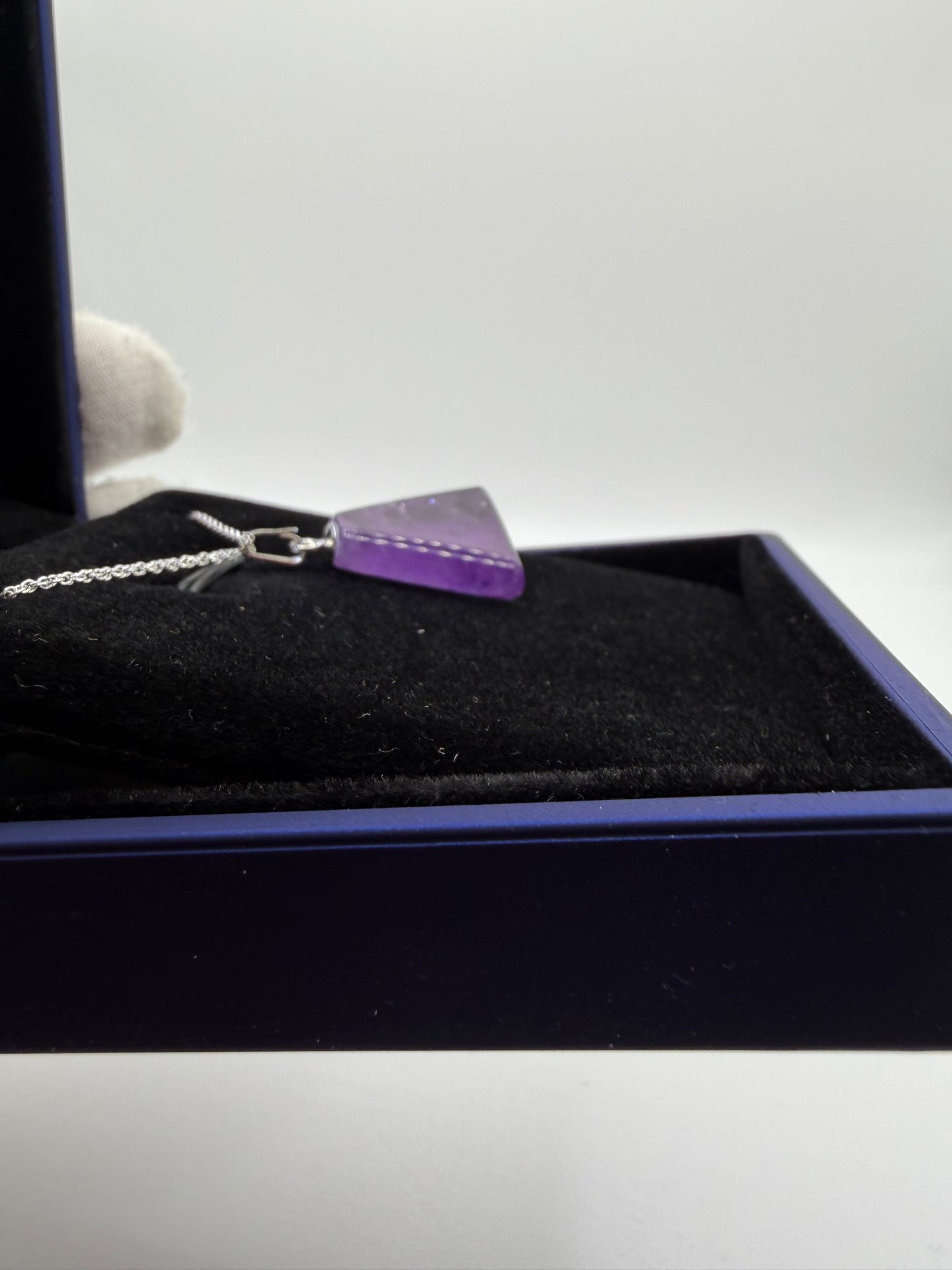 Natural untreated Rwandan amethyst stone in triangular shape set in sterling silver pendant with chain from Maine