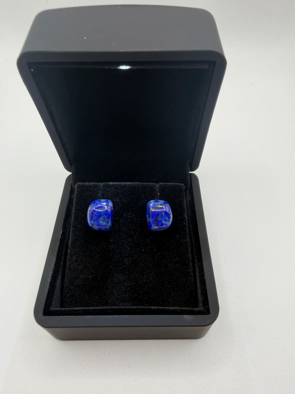 13tcw natural lapis lazuli rectangular barrel cabochon stud earrings in deep royal blue, displayed in open black jewelry box