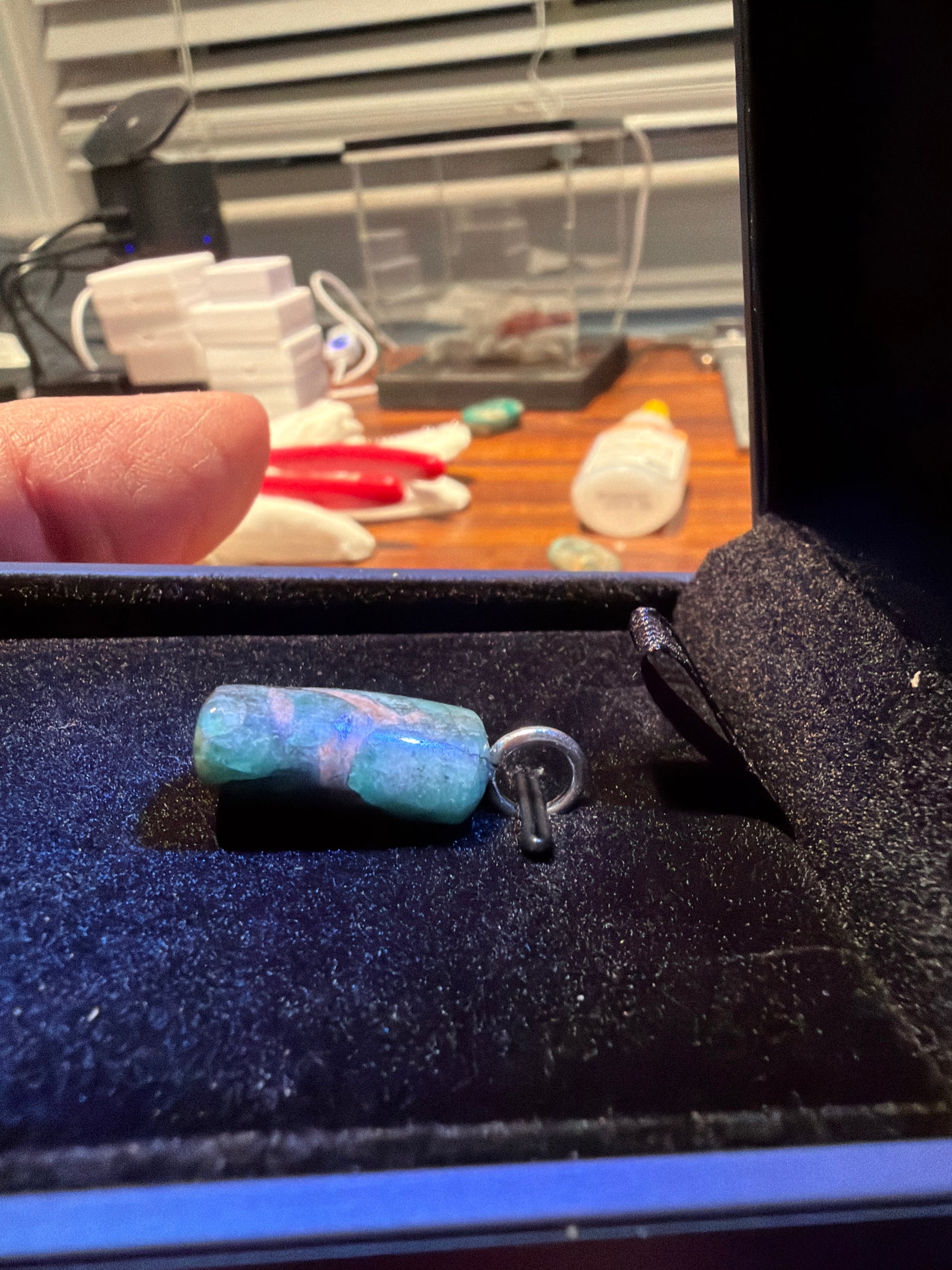 Side view of 19ct Bullish Breakout Emerald cabochon, natural green color and unique shape