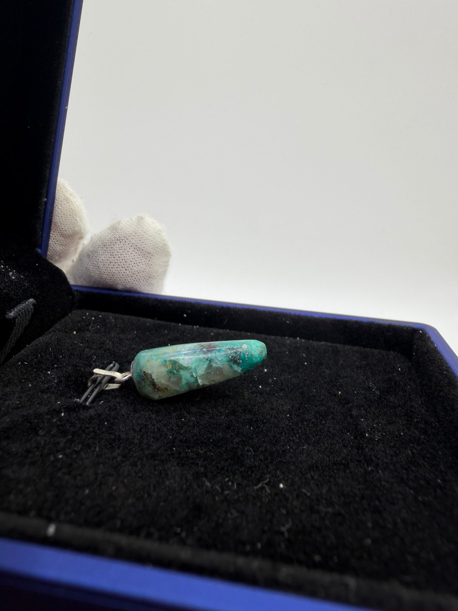 Side view of Namibian Quantum Quattro natural gemstone pendant with sterling silver bail — one-of-a-kind handcrafted jewelry
