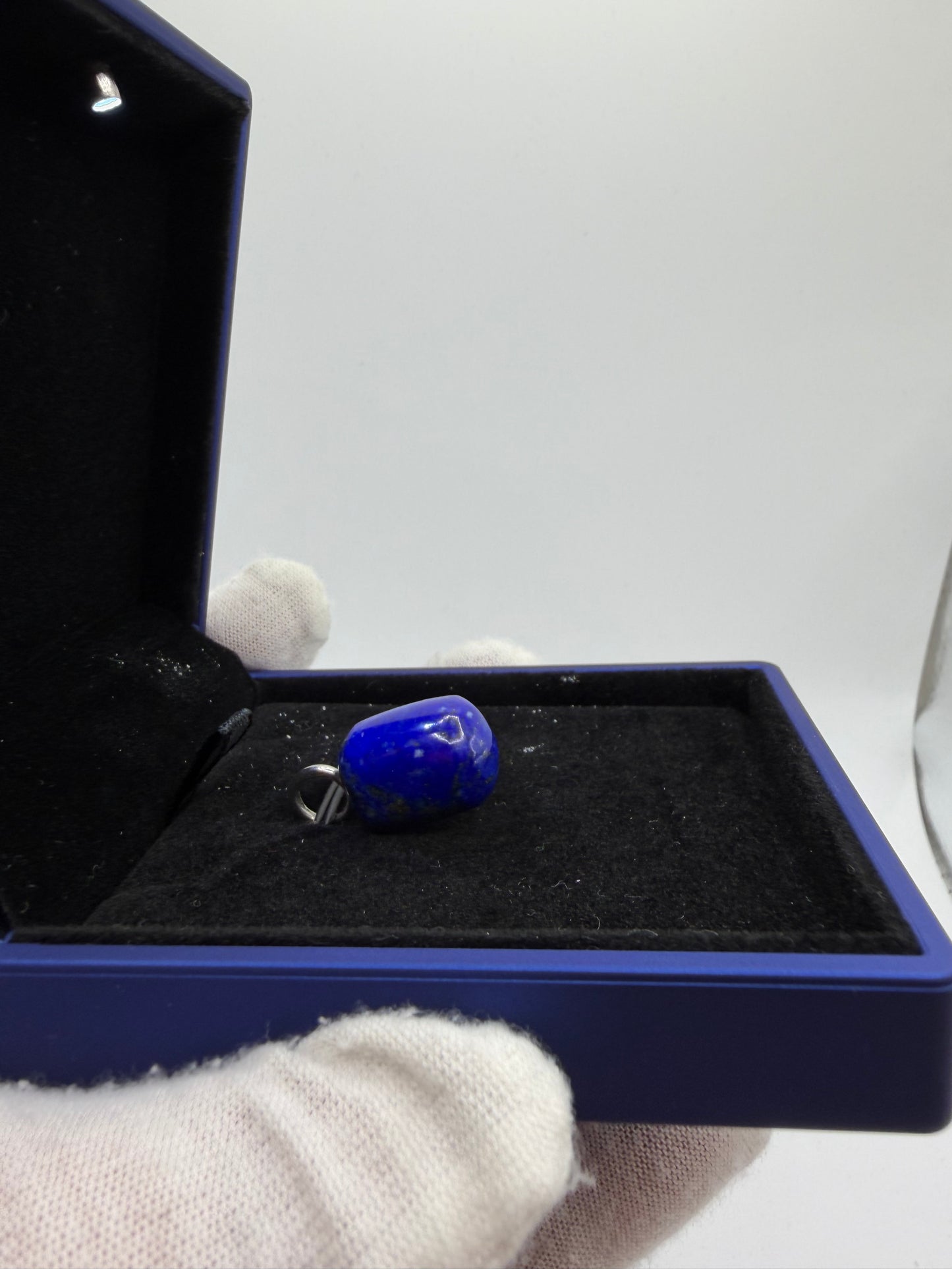 Detail of 34ct Lapis Lazuli pendant stone surface — natural deep blue gemstone with pyrite inclusions, made in Maine