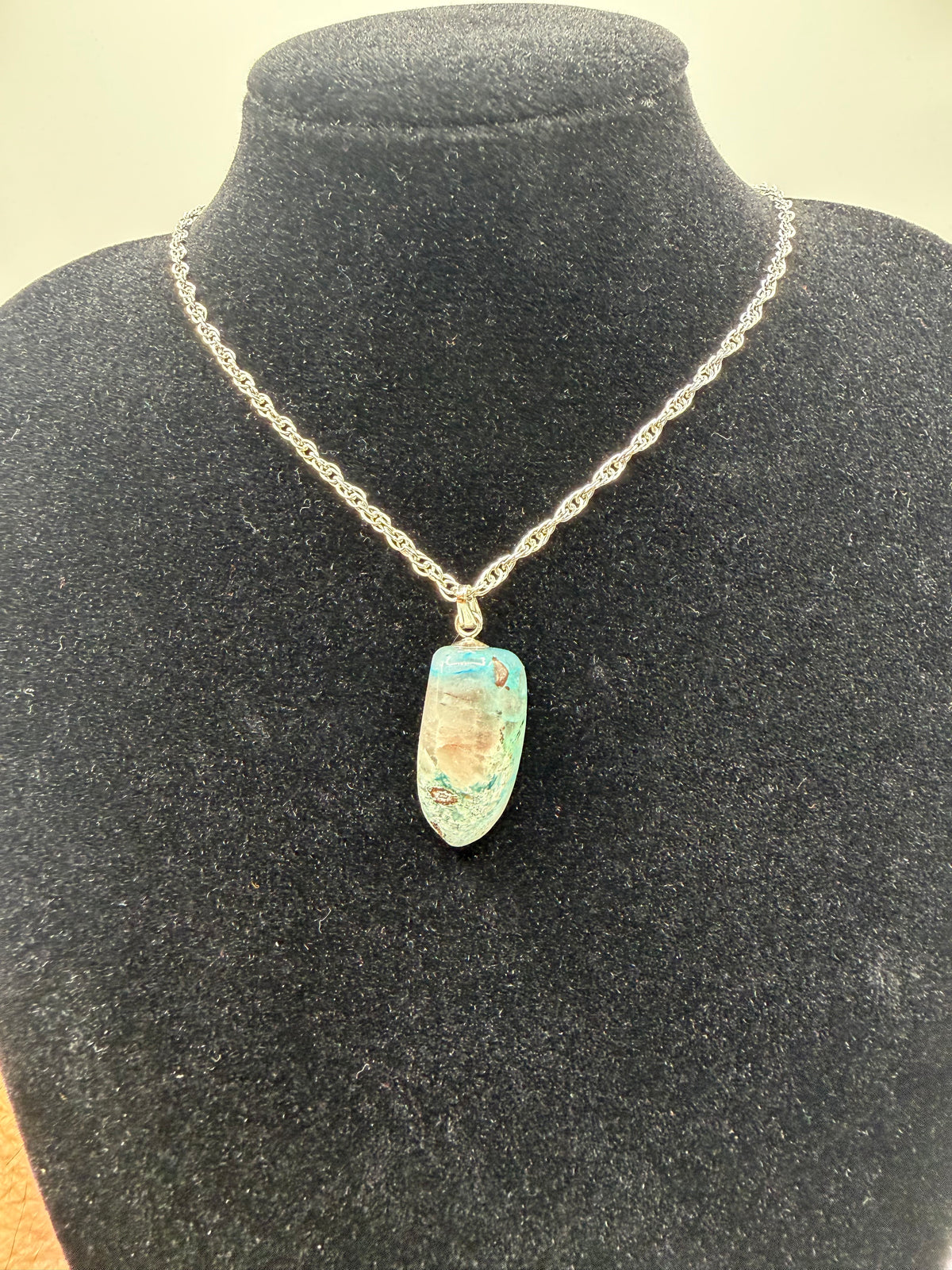 18ct Namibian Quantum Quattro pendant in soft teal-blue on a rope chain display, handcrafted in Maine