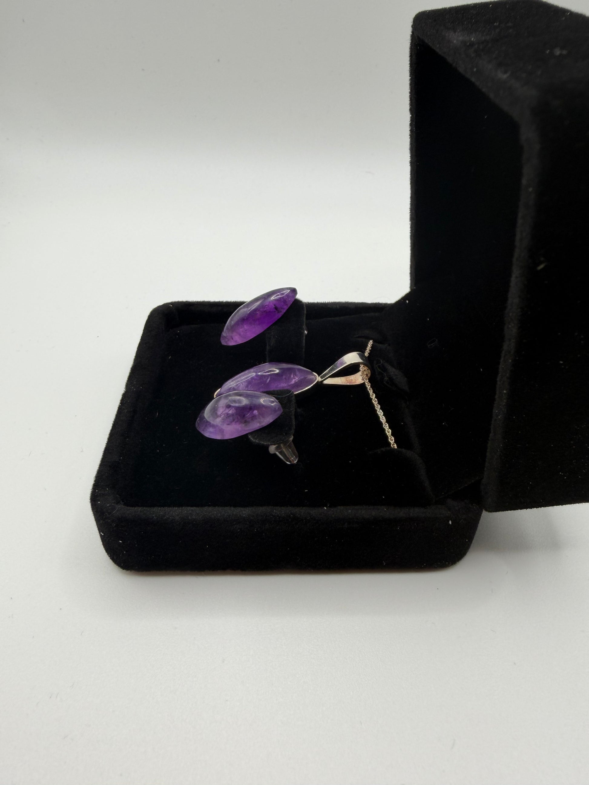 Rwandan Amethyst slender oval pendant and earring set showing deep purple stones