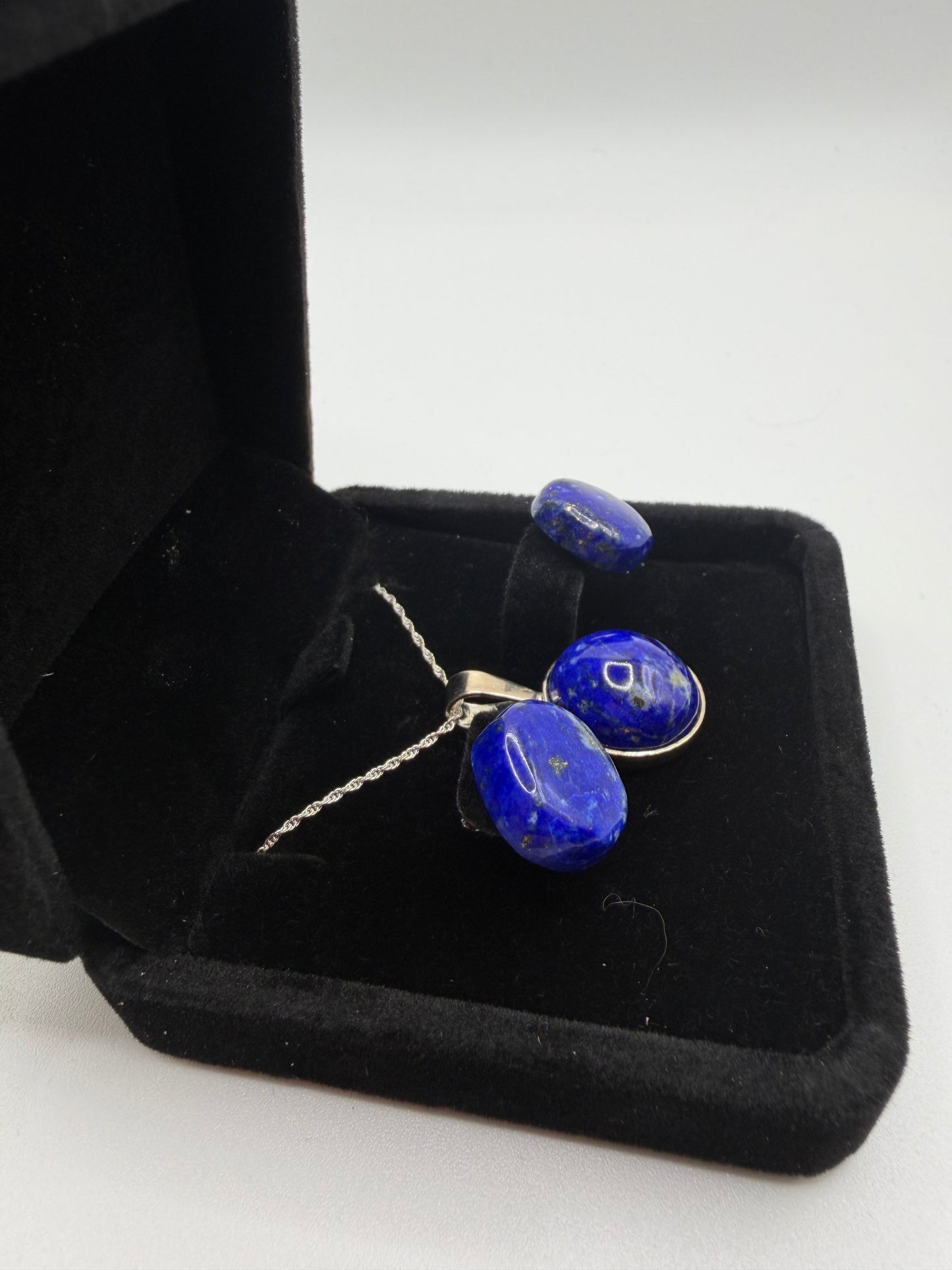 Lapis lazuli pendant and earring set showing deep blue stones with golden pyrite flecks