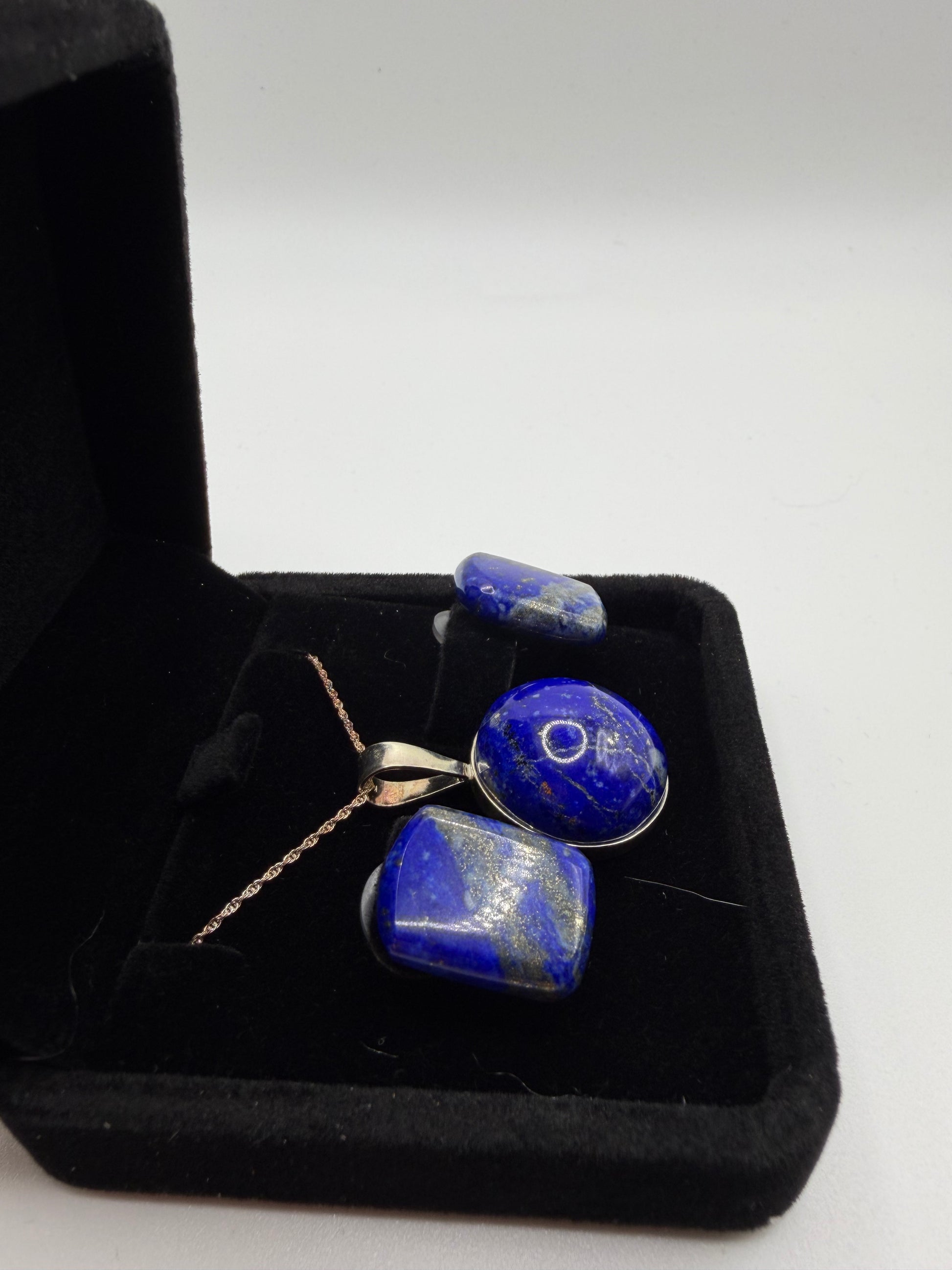 Lapis lazuli pendant and earring set showing deep blue stones with golden pyrite flecks