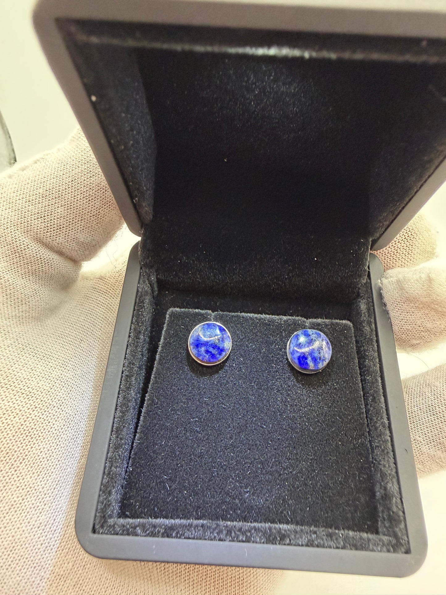 Close-up of 8mm natural lapis lazuli cabochon with golden pyrite flecks in titanium setting