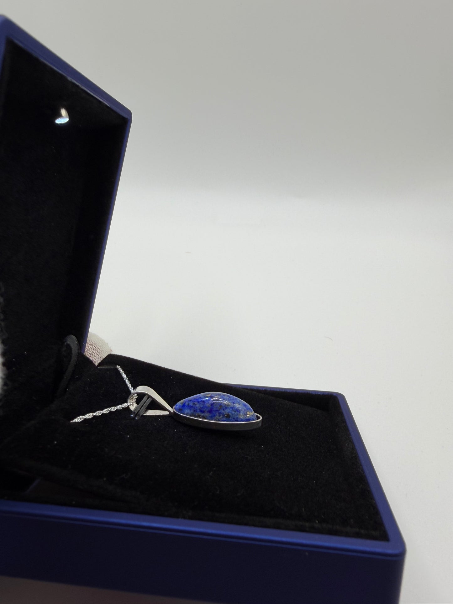 Sterling silver bail and 18 inch 1mm rope chain on slender oval lapis lazuli pendant handcrafted in Maine