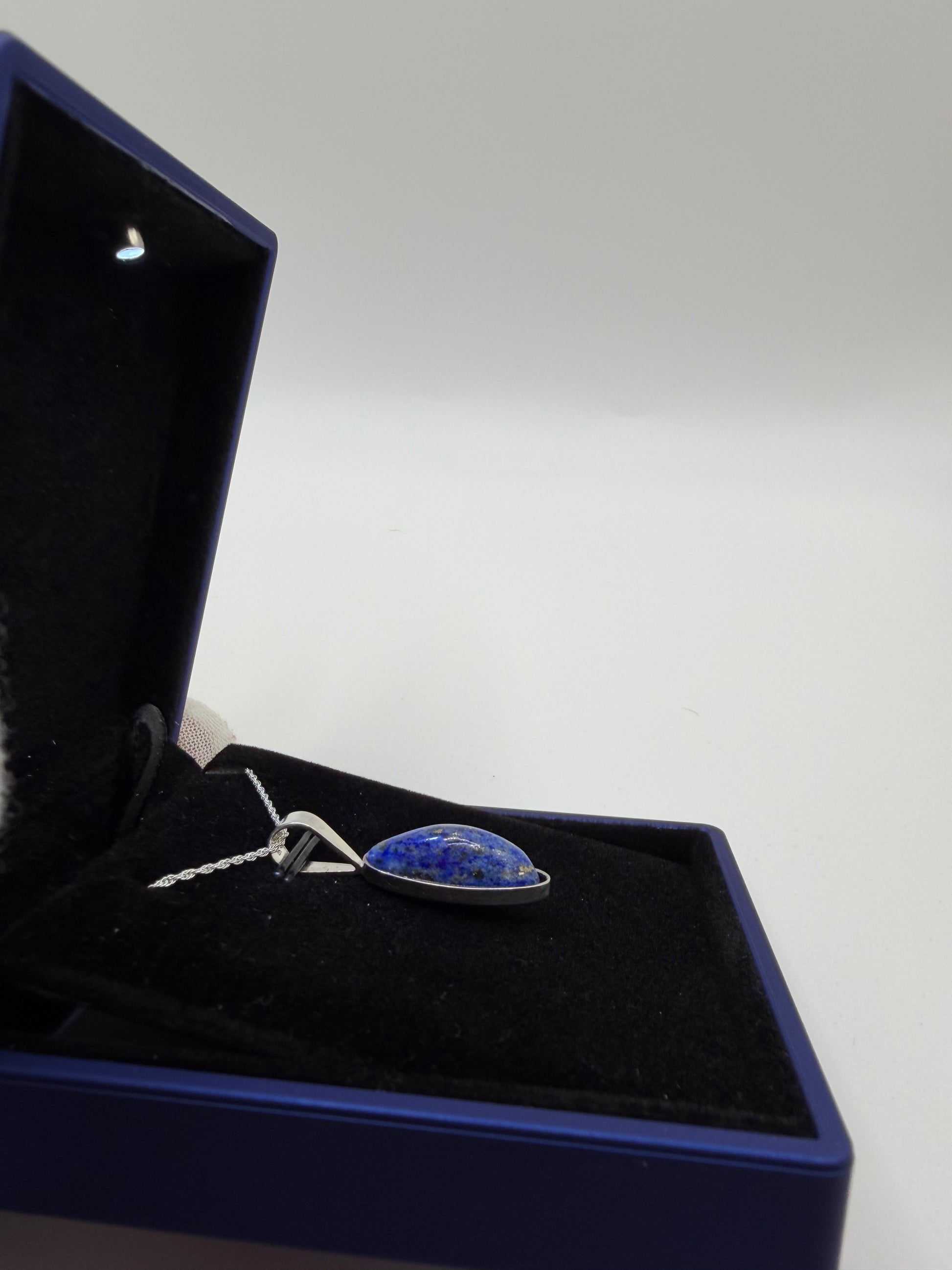 Sterling silver bail and 18 inch 1mm rope chain on slender oval lapis lazuli pendant handcrafted in Maine