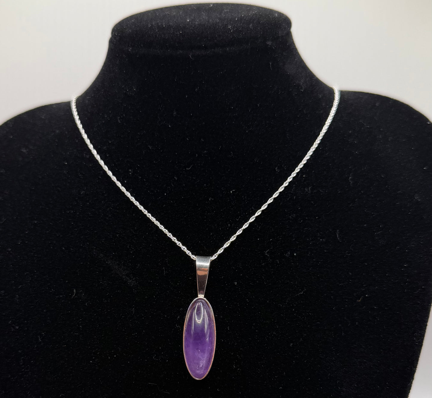 Slender oval Rwandan Amethyst pendant handcrafted in Maine sterling silver with 18 inch chain included