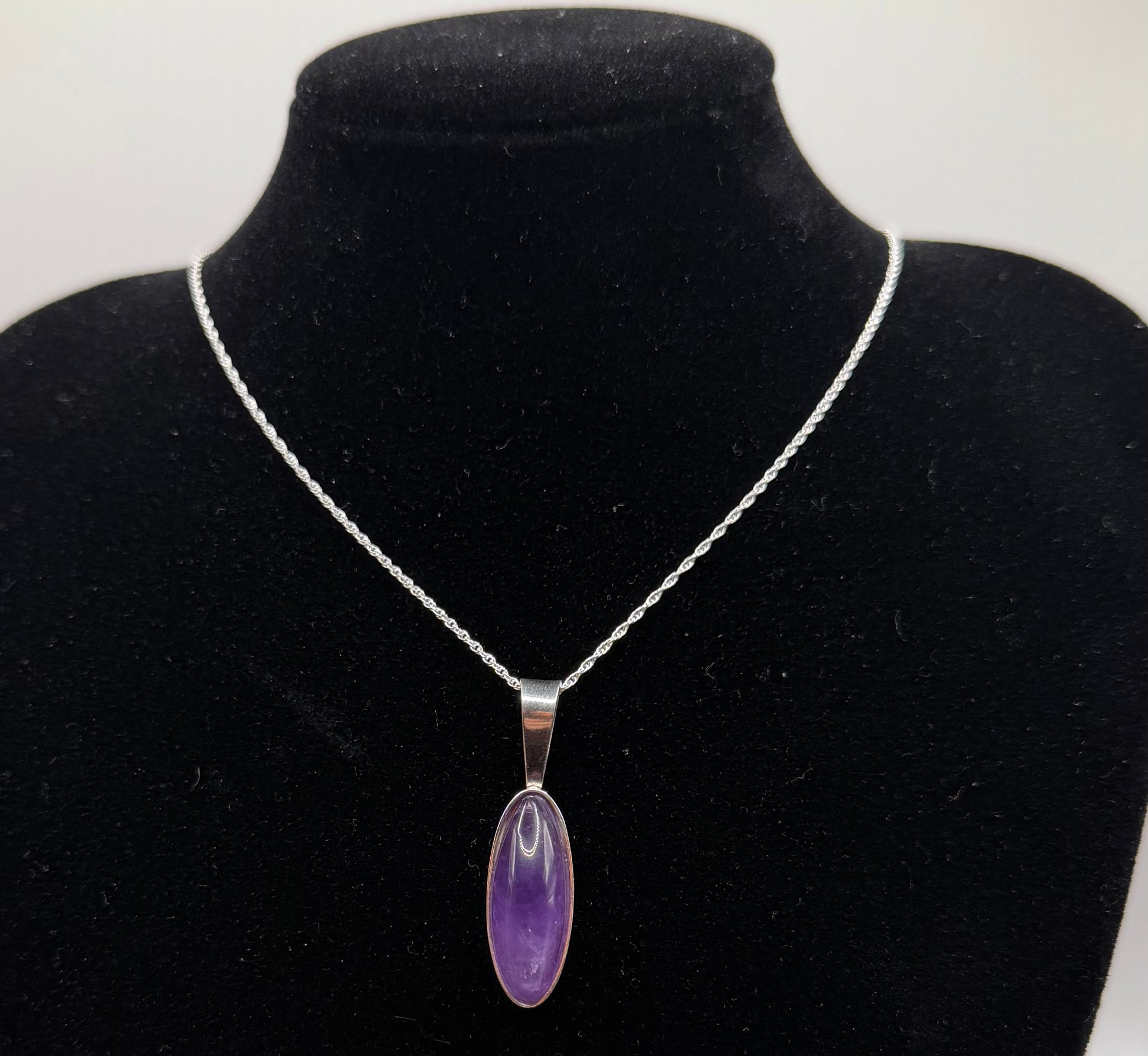 Slender oval Rwandan Amethyst pendant handcrafted in Maine sterling silver with 18 inch chain included