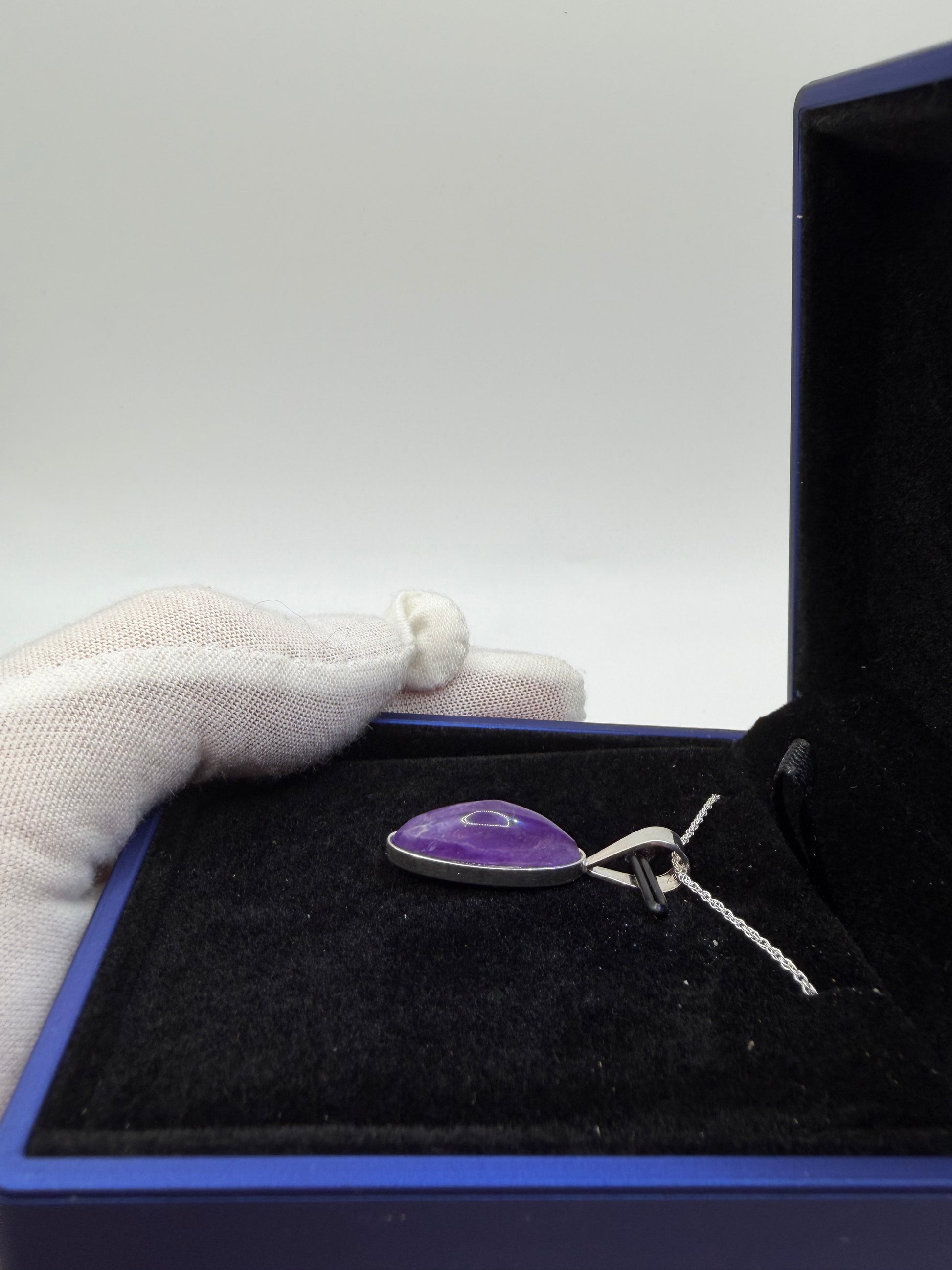 Natural untreated Rwandan amethyst stone in slender oval shape set in sterling silver pendant with chain from Maine