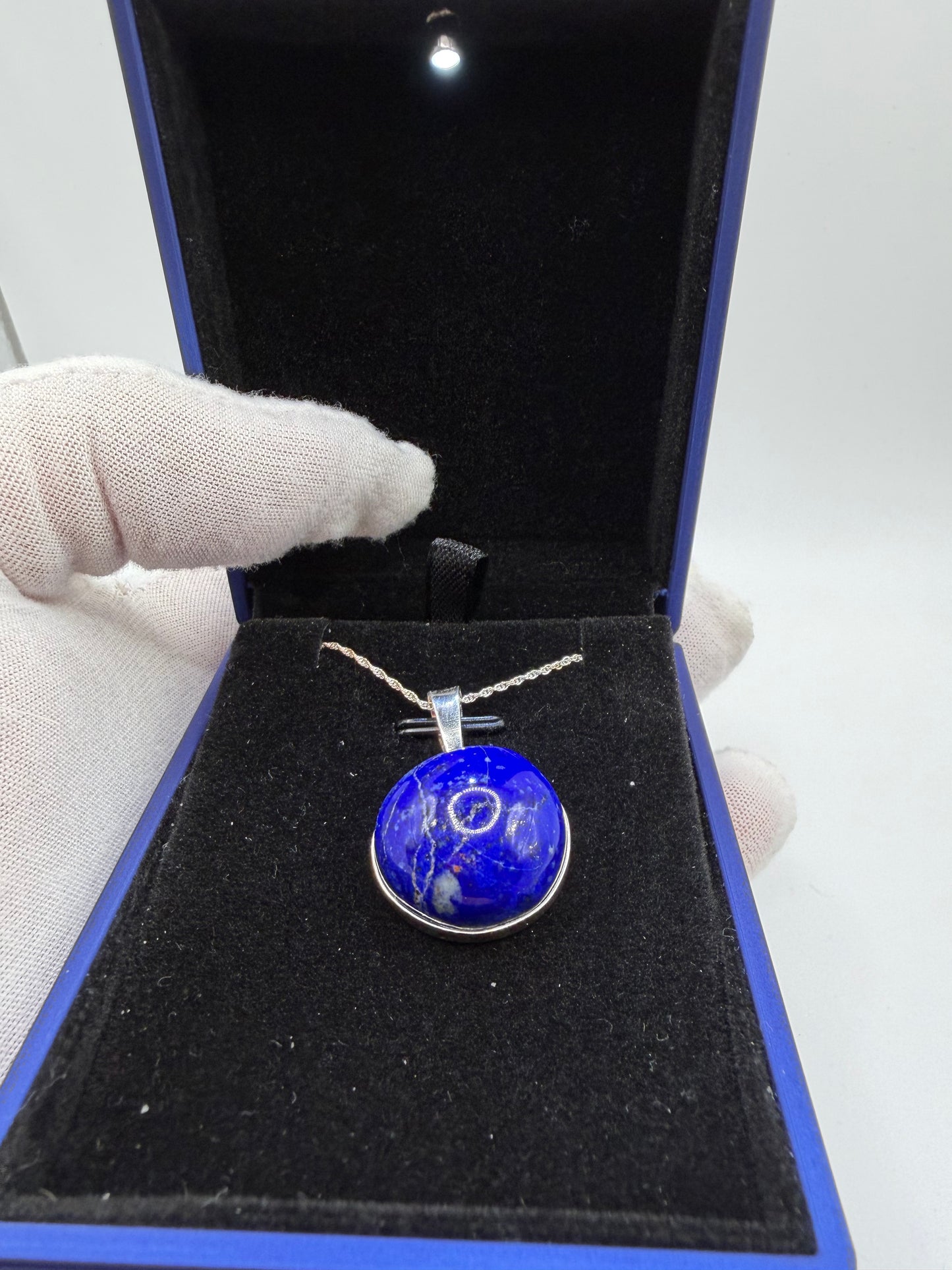 Close-up of 20mm natural lapis lazuli cabochon showing deep blue color and golden pyrite flecks