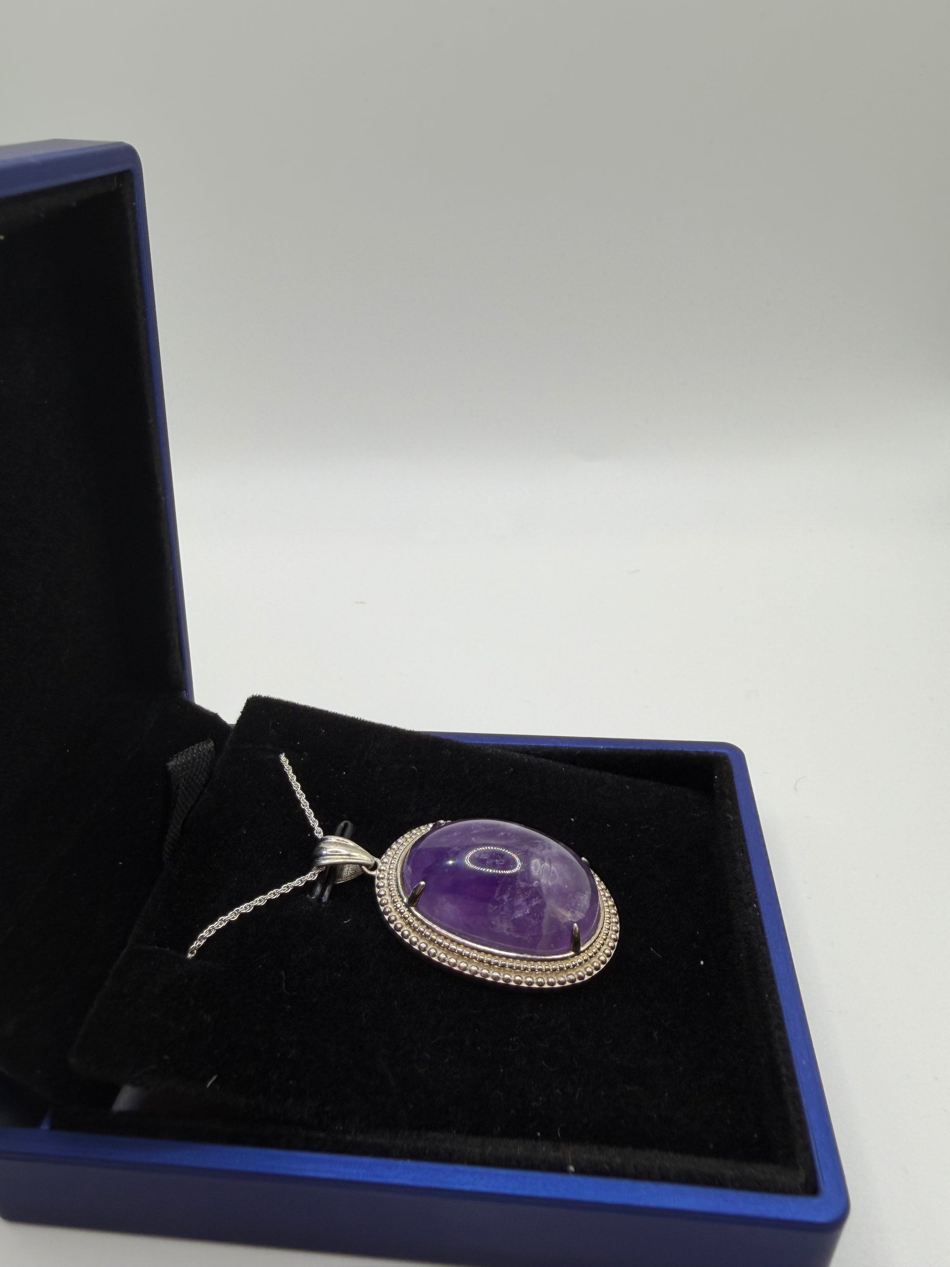 Natural untreated Rwandan amethyst stone set in sterling silver pendant with chain from Maine
