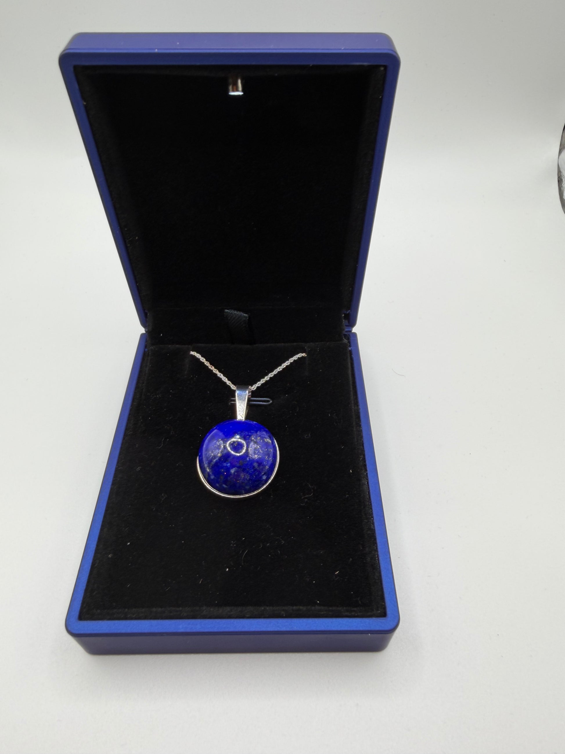 Close-up of 20mm natural lapis lazuli cabochon showing deep blue color and golden pyrite flecks