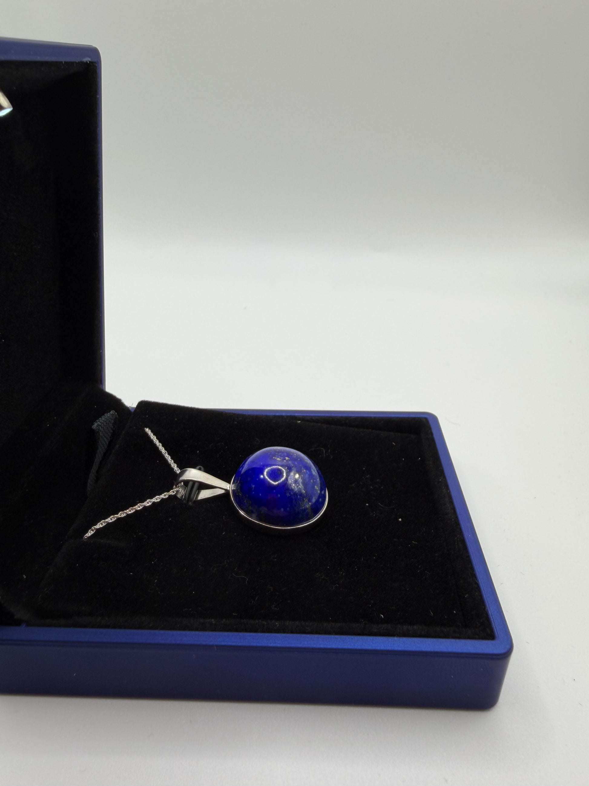Natural untreated lapis lazuli stone with golden pyrite inclusions set in sterling silver pendant with chain from Maine