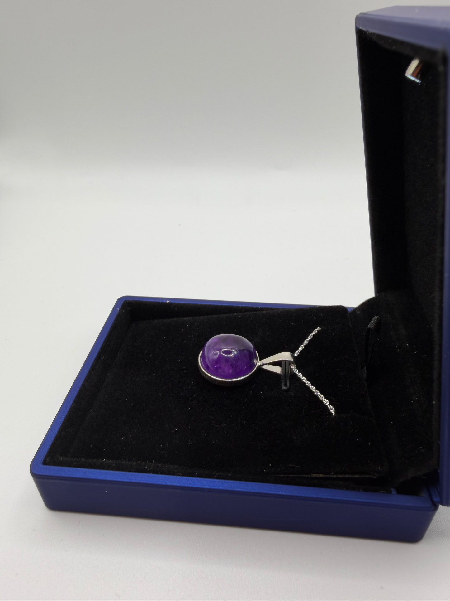 Natural untreated Rwandan amethyst stone set in sterling silver pendant with chain from Maine