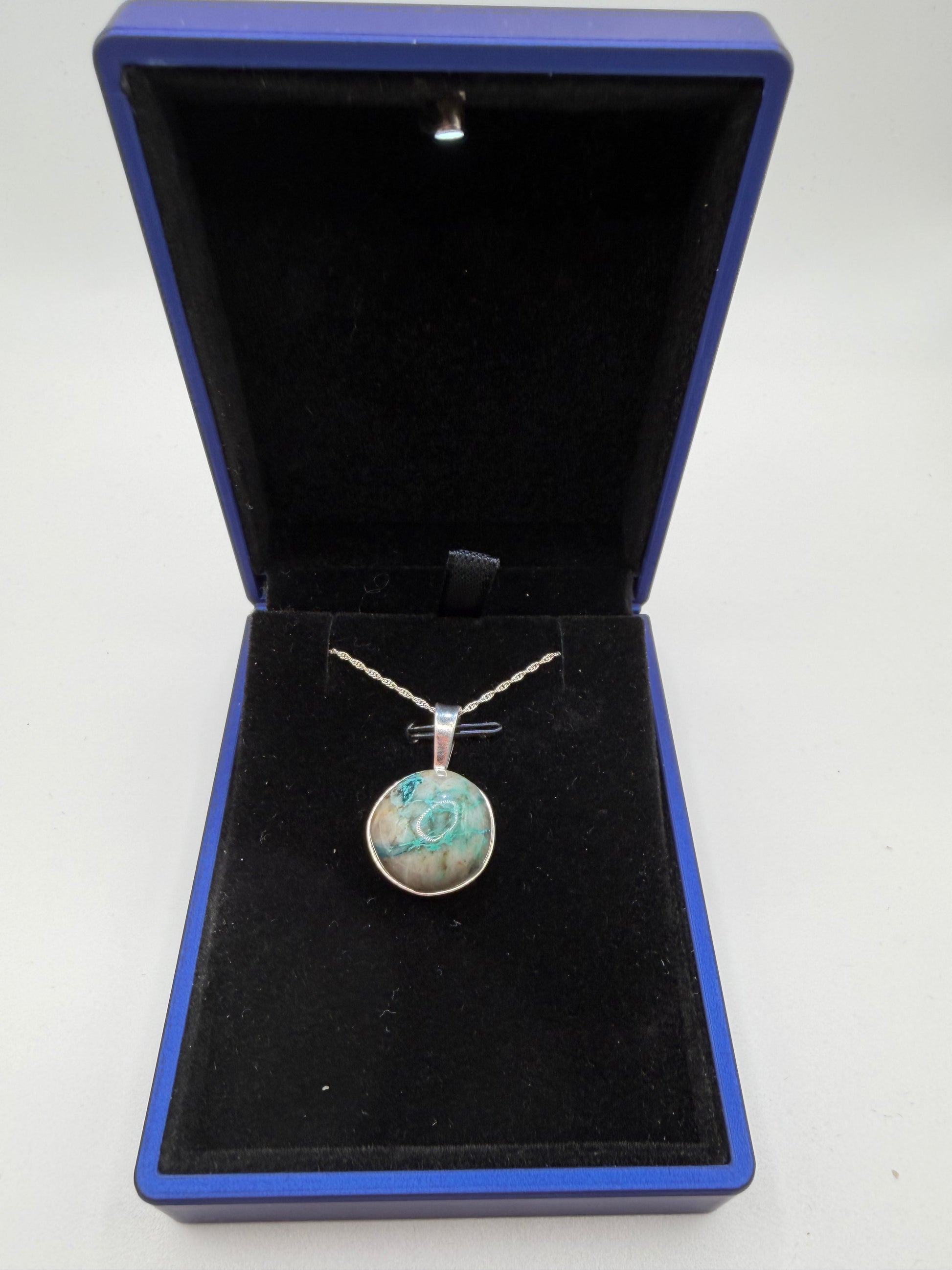 Close-up of Quantum Quattro cabochon from Namibia showing deep blue Shattuckite and green matrix patterns