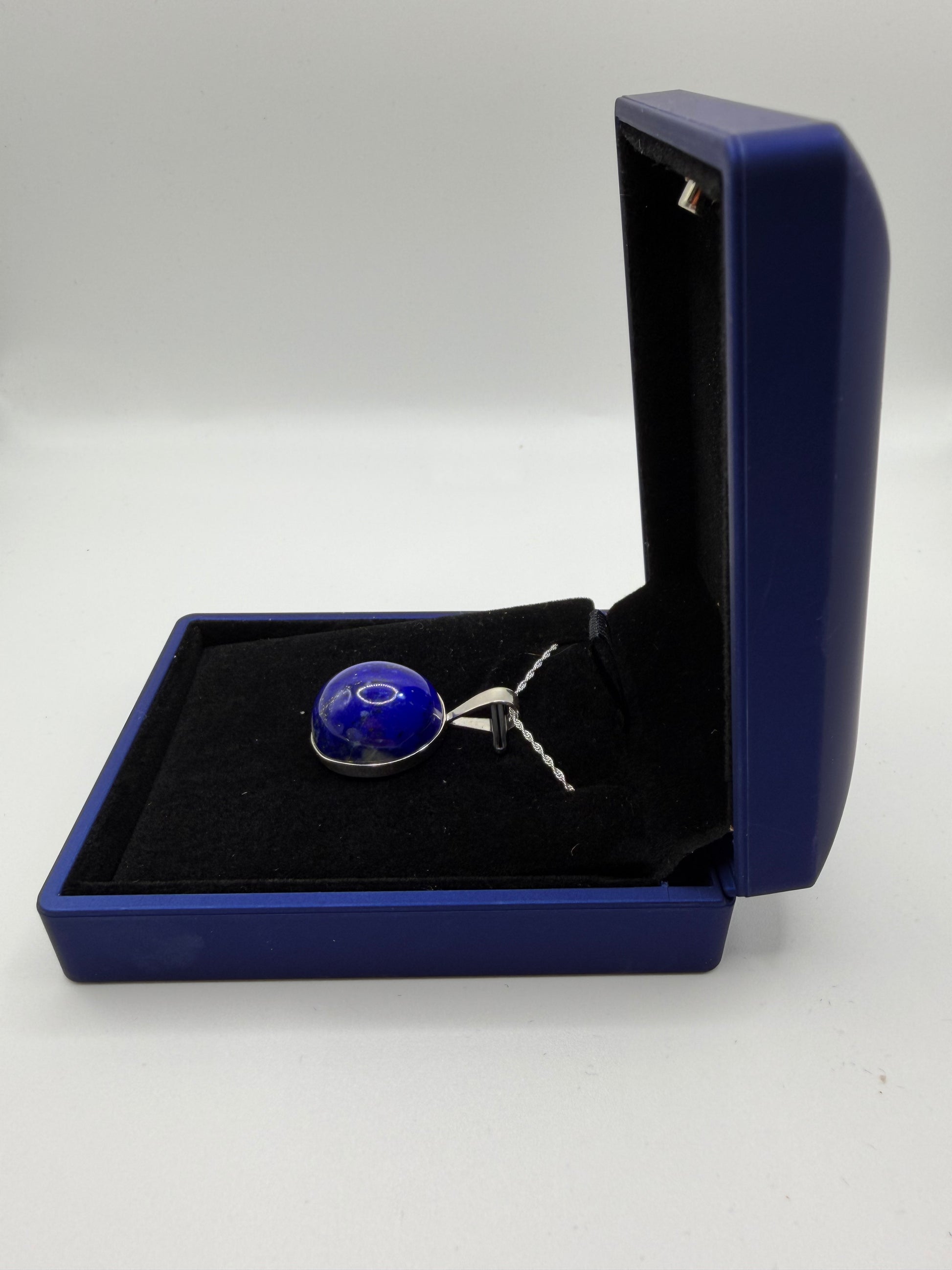 Natural untreated lapis lazuli stone with golden pyrite inclusions set in sterling silver pendant with chain from Maine