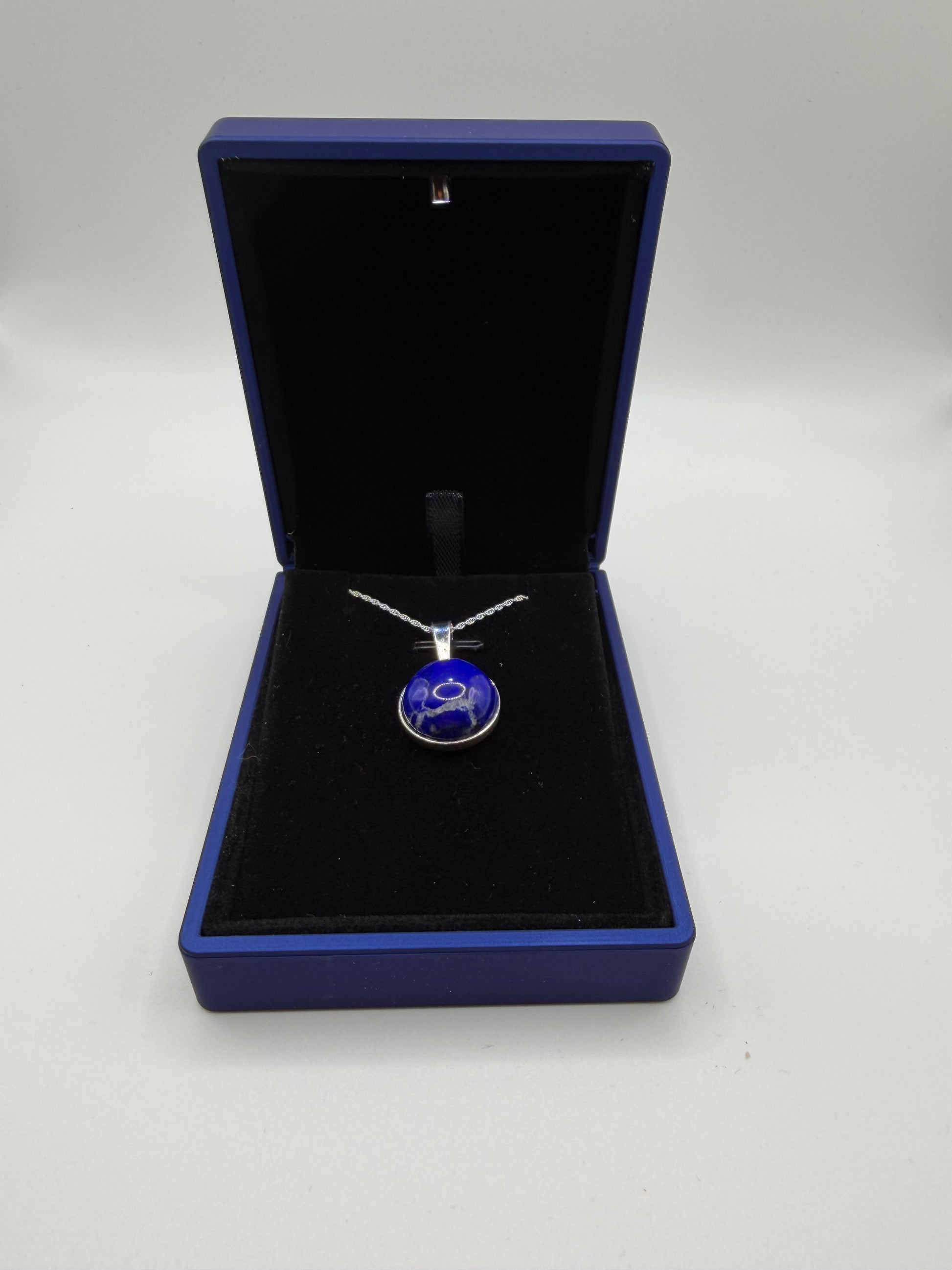 Close-up of 16mm natural lapis lazuli cabochon showing deep blue color and golden pyrite flecks