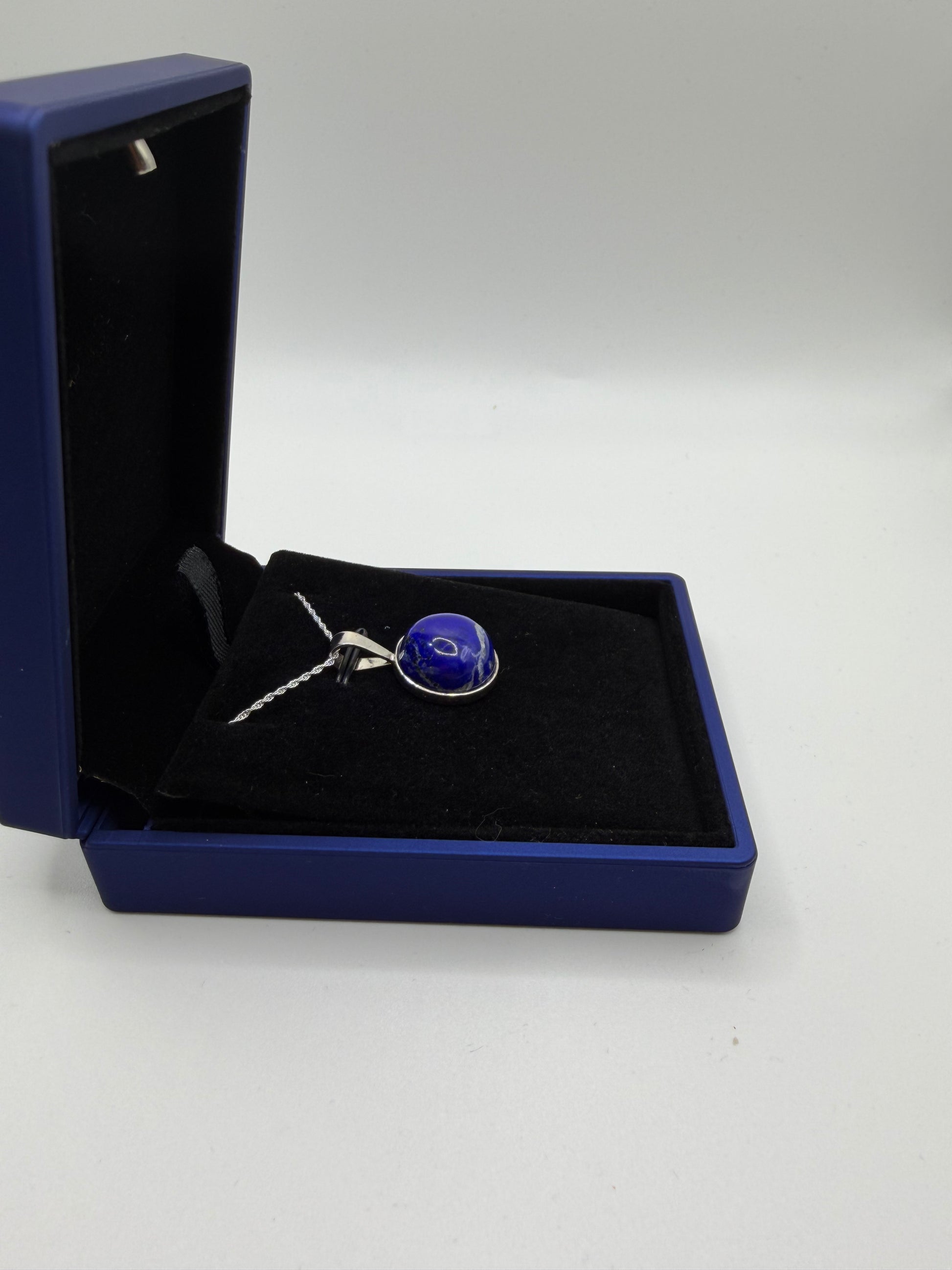 Natural untreated lapis lazuli stone with golden pyrite inclusions set in sterling silver pendant handcrafted in Maine