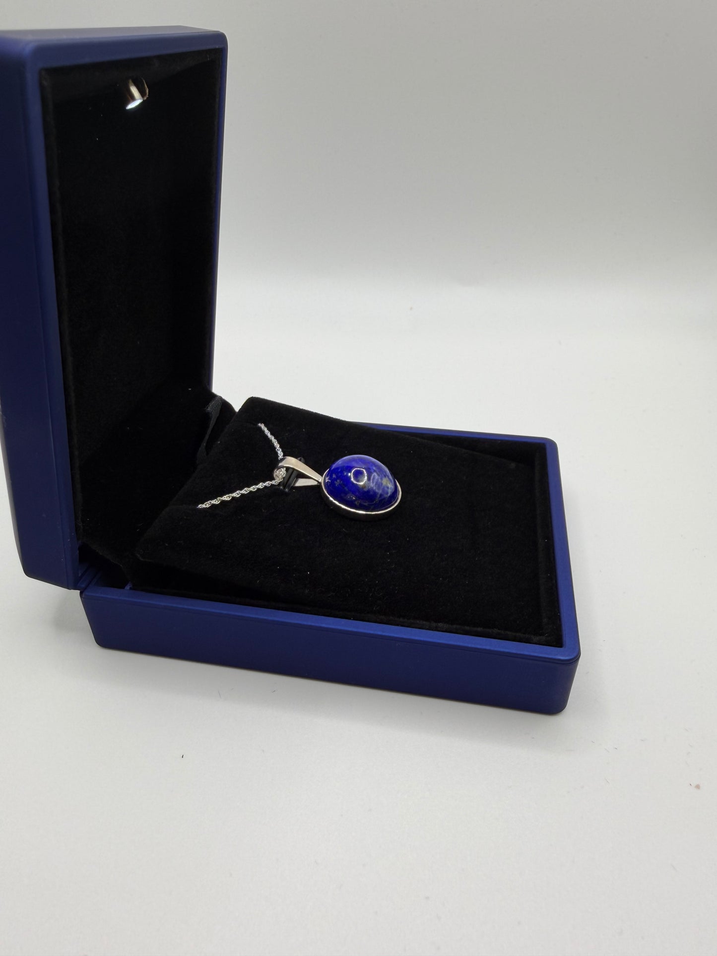 Untreated natural lapis lazuli stone with pyrite inclusions before setting in sterling silver pendant