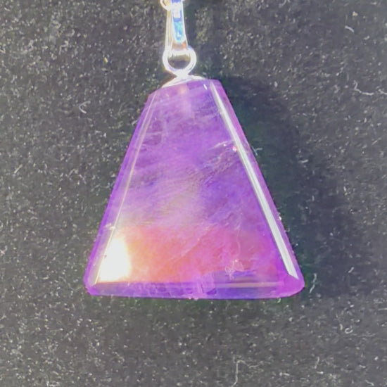 Video of 16ct Rwandan Amethyst triangular pendant rotating to show deep purple color and natural clarity, handcrafted in Maine with chain