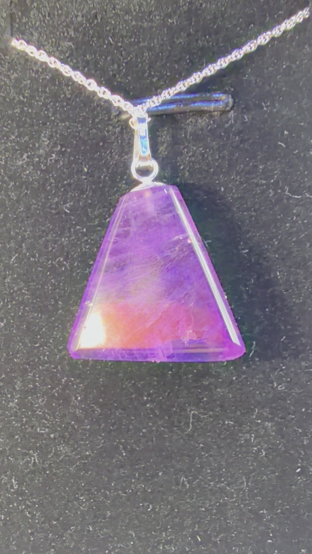 Video of 16ct Rwandan Amethyst triangular pendant rotating to show deep purple color and natural clarity, handcrafted in Maine with chain