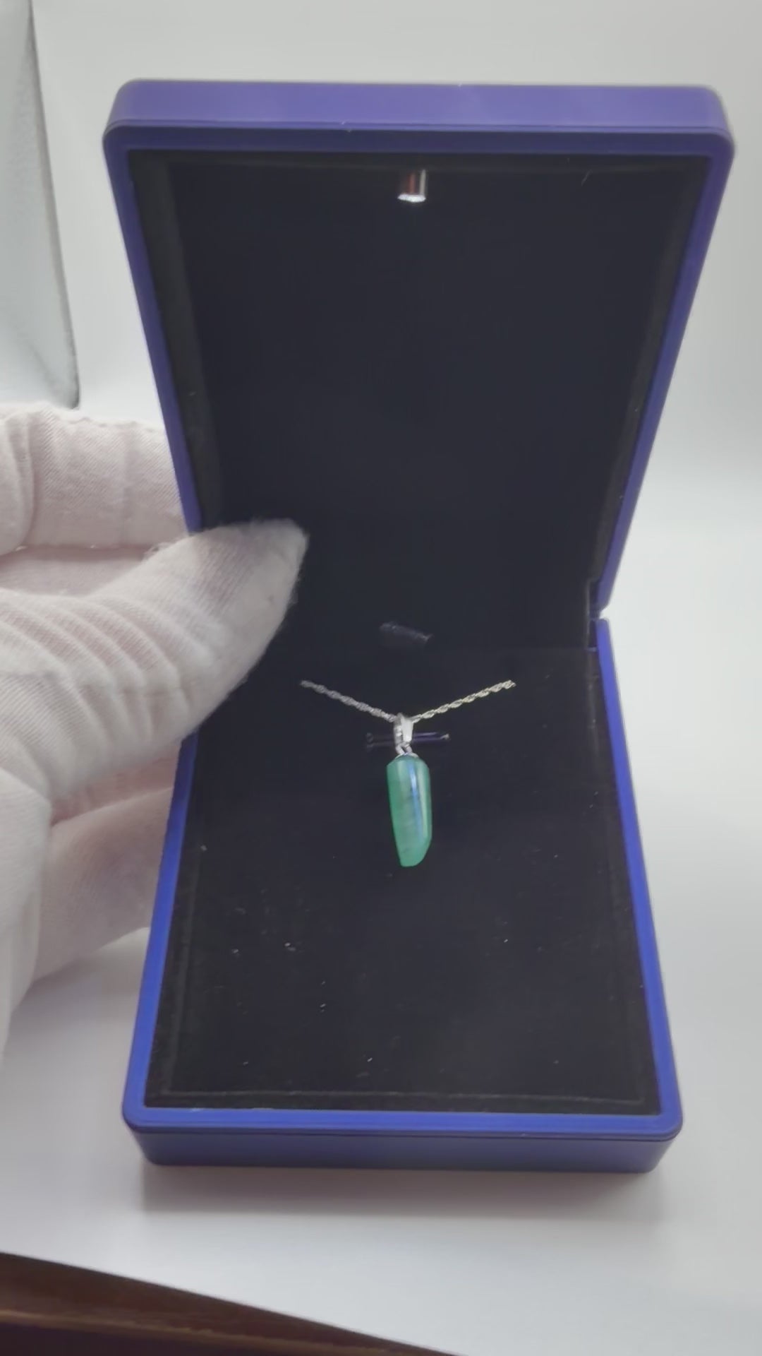 Video of 4.7ct Colombian emerald pendant rotating to show rich green color and natural facets in sterling silver setting, handcrafted in Maine with chain