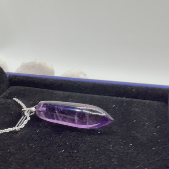 Video of 16ct Rwandan Amethyst pendant rotating to show deep purple color and natural clarity, handcrafted in Maine with chain