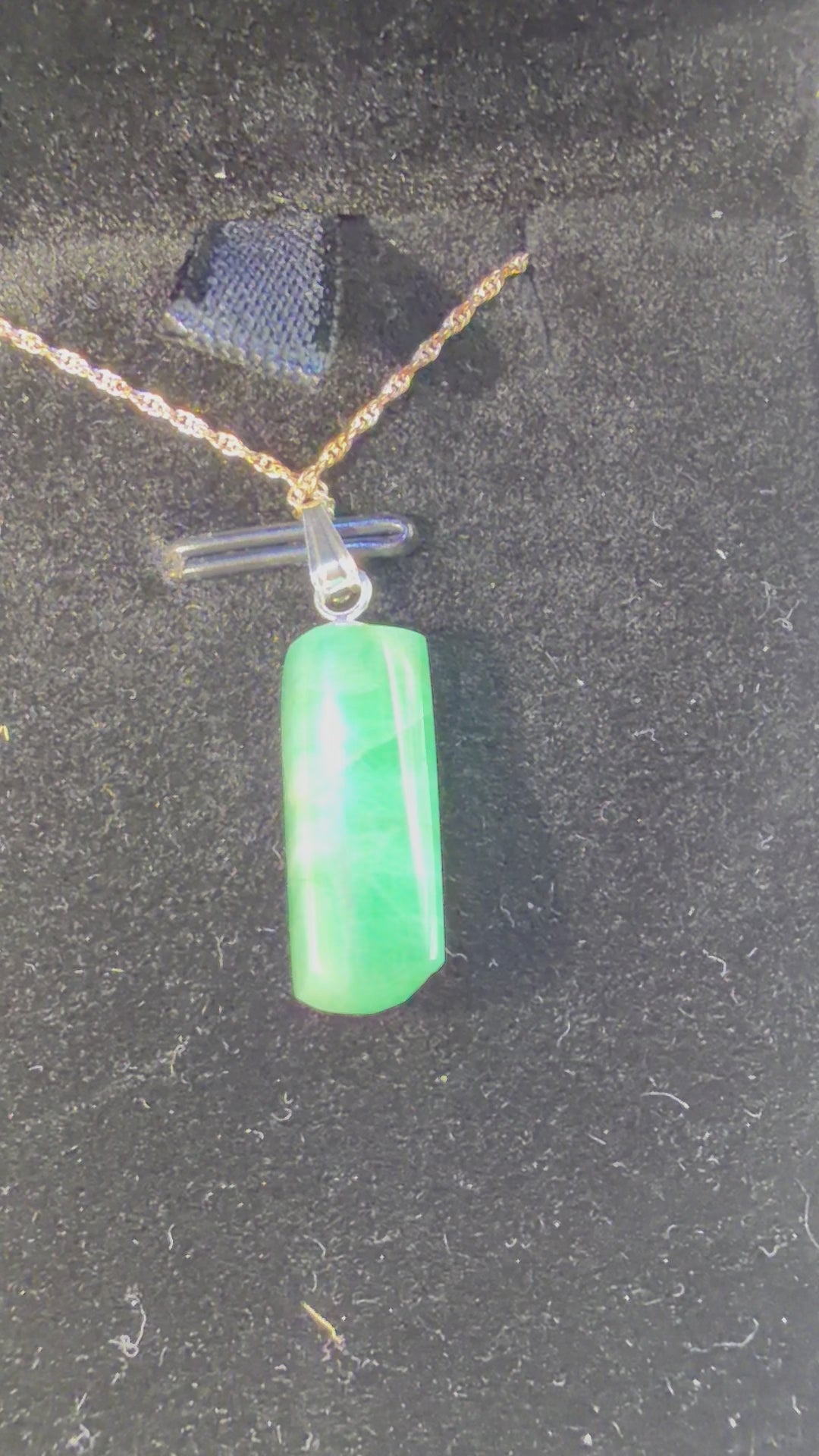 Video of 8ct Colombian emerald pendant rotating to show rich green color and natural facets in sterling silver setting, handcrafted in Maine with chain